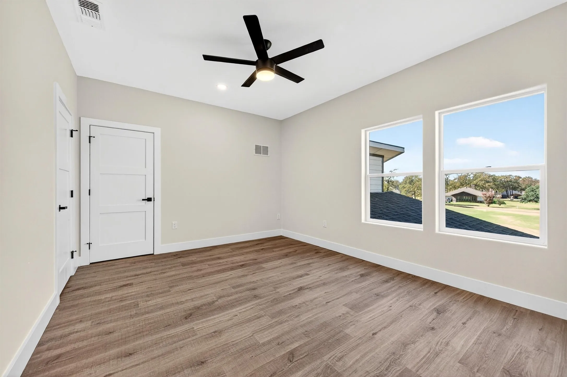 Empty room with light wood-style flooring, ceiling fan, and recessed lighting