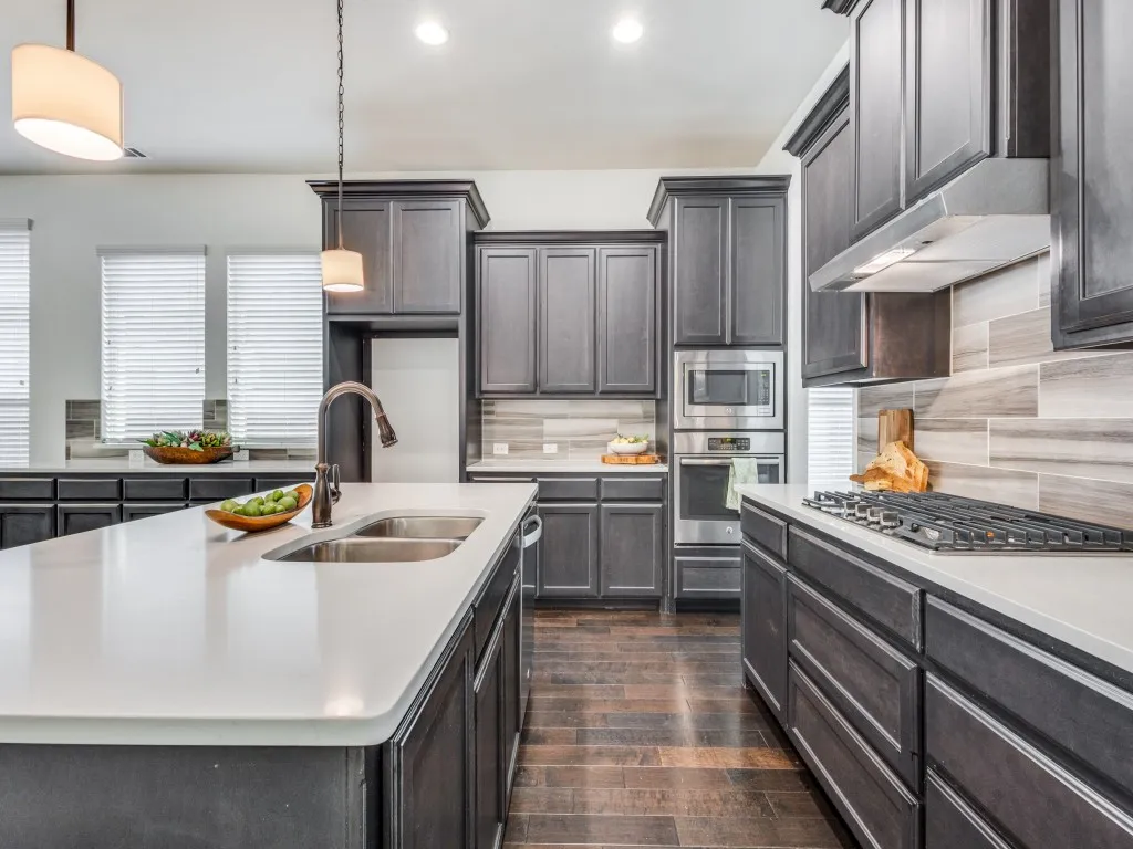 Kitchen with pendant lighting, stainless steel appliances, new cook top, recessed lighting, backsplash, and plenty of cabinets.