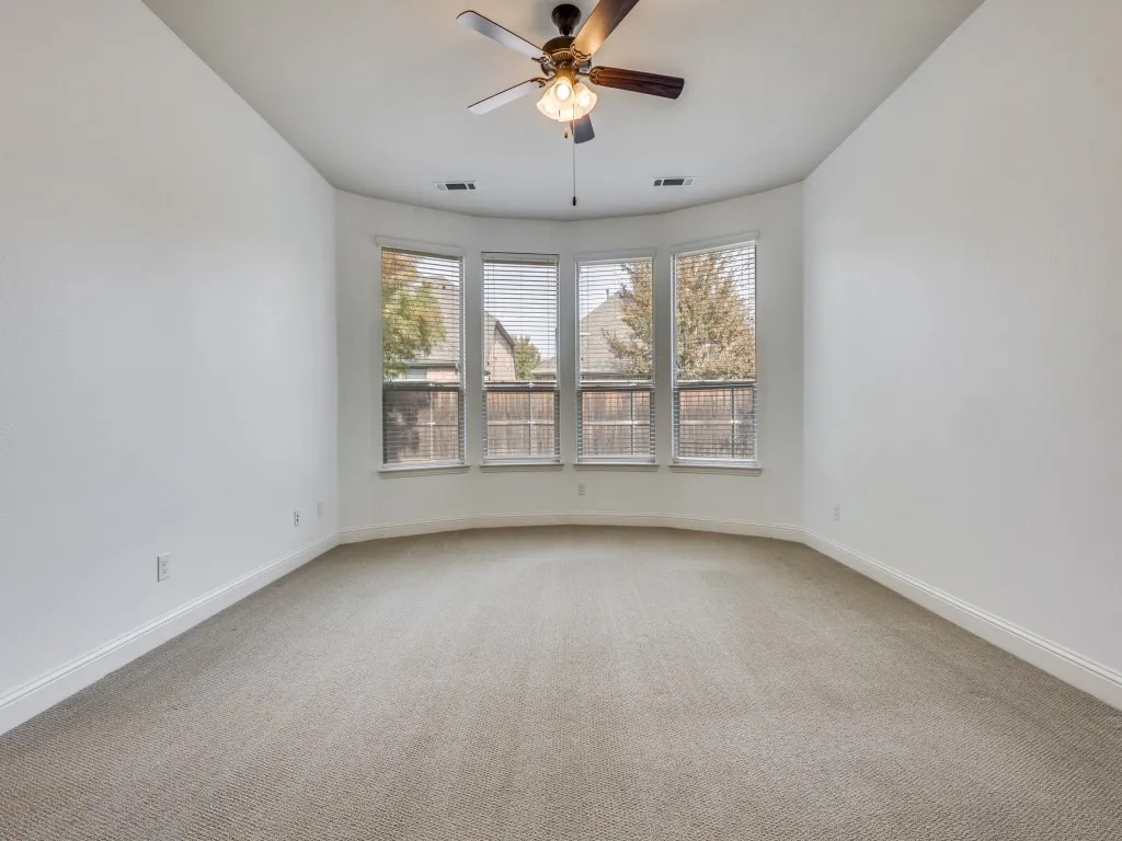 Primary bedroom with windows to the back yard.