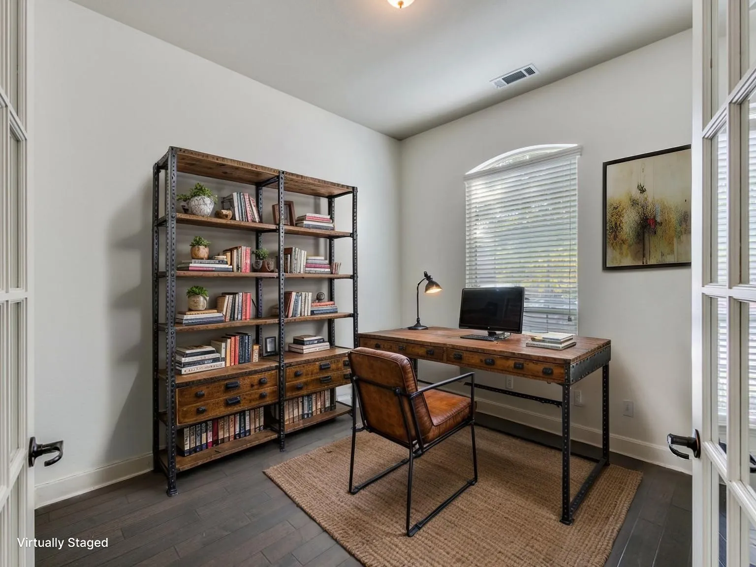 Dedicated office space featuring dark wood-finish flooring, white walls, and a recessed ceiling light