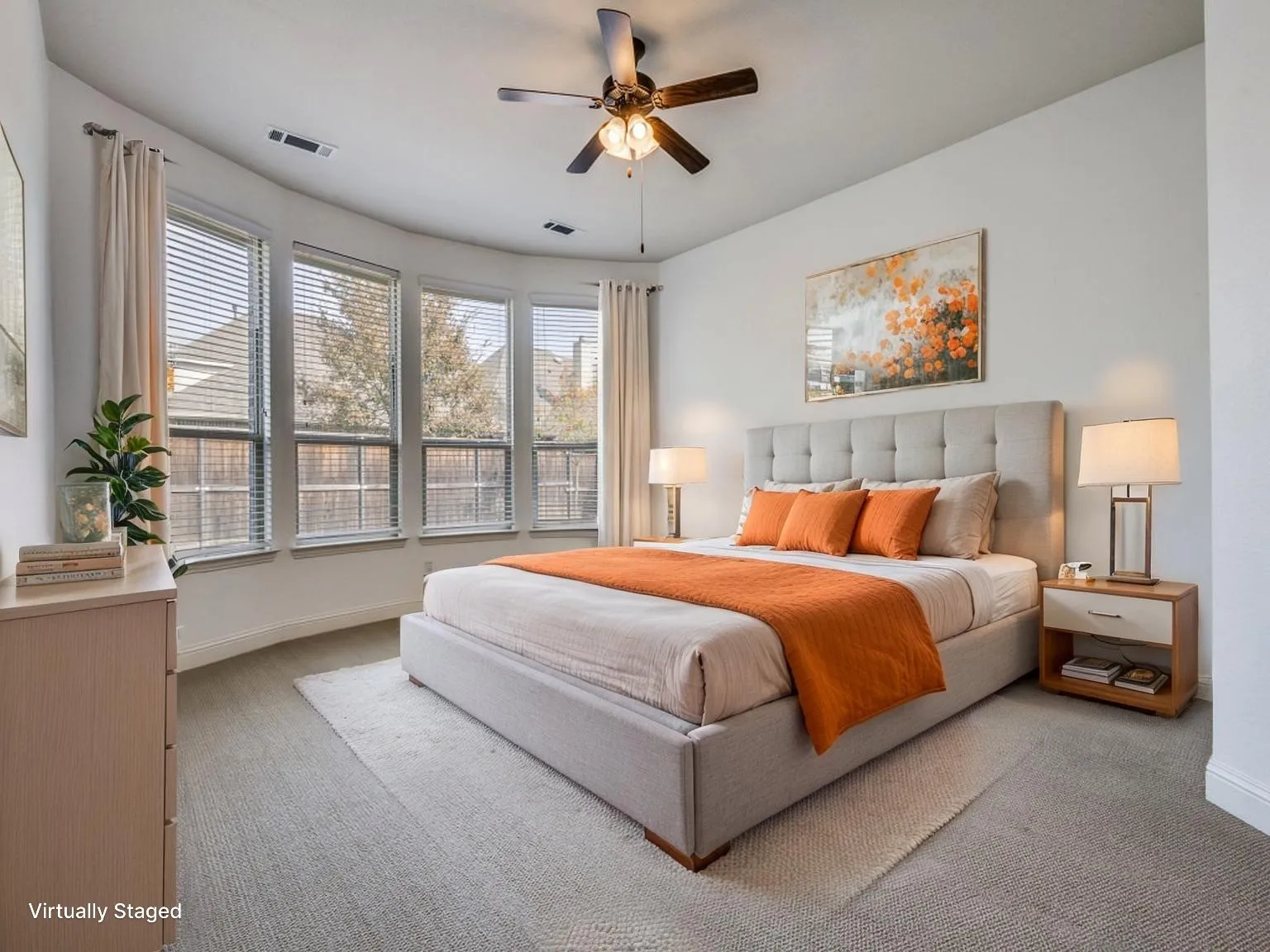 Bay window with multiple large windows, ceiling fan with light fixture, plush carpet flooring, recessed lighting, and a neutral color palette