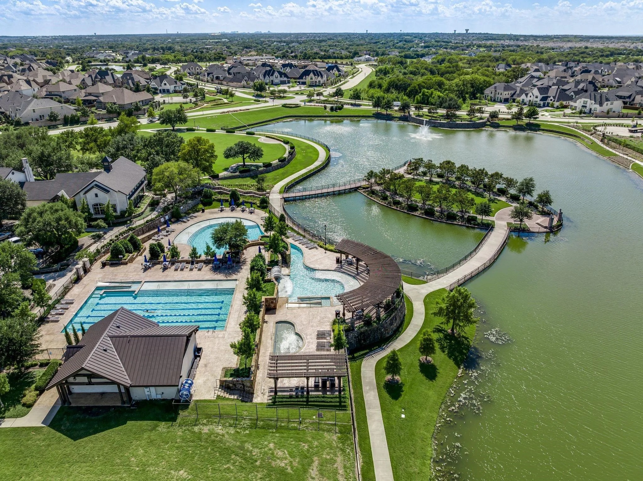 Community amenities featuring a large resort-style pool with integrated spa, a lap pool, and a children's splash pool