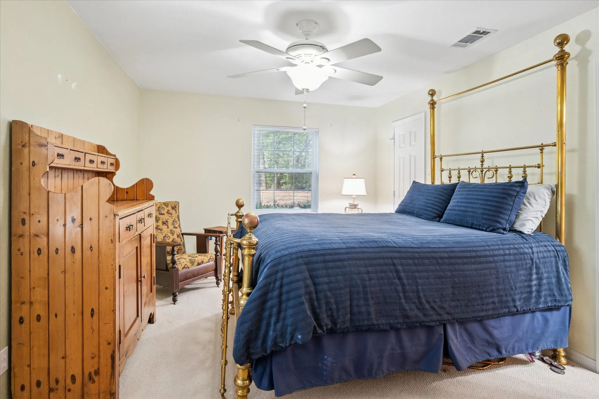 Carpeted bedroom with ceiling fan
