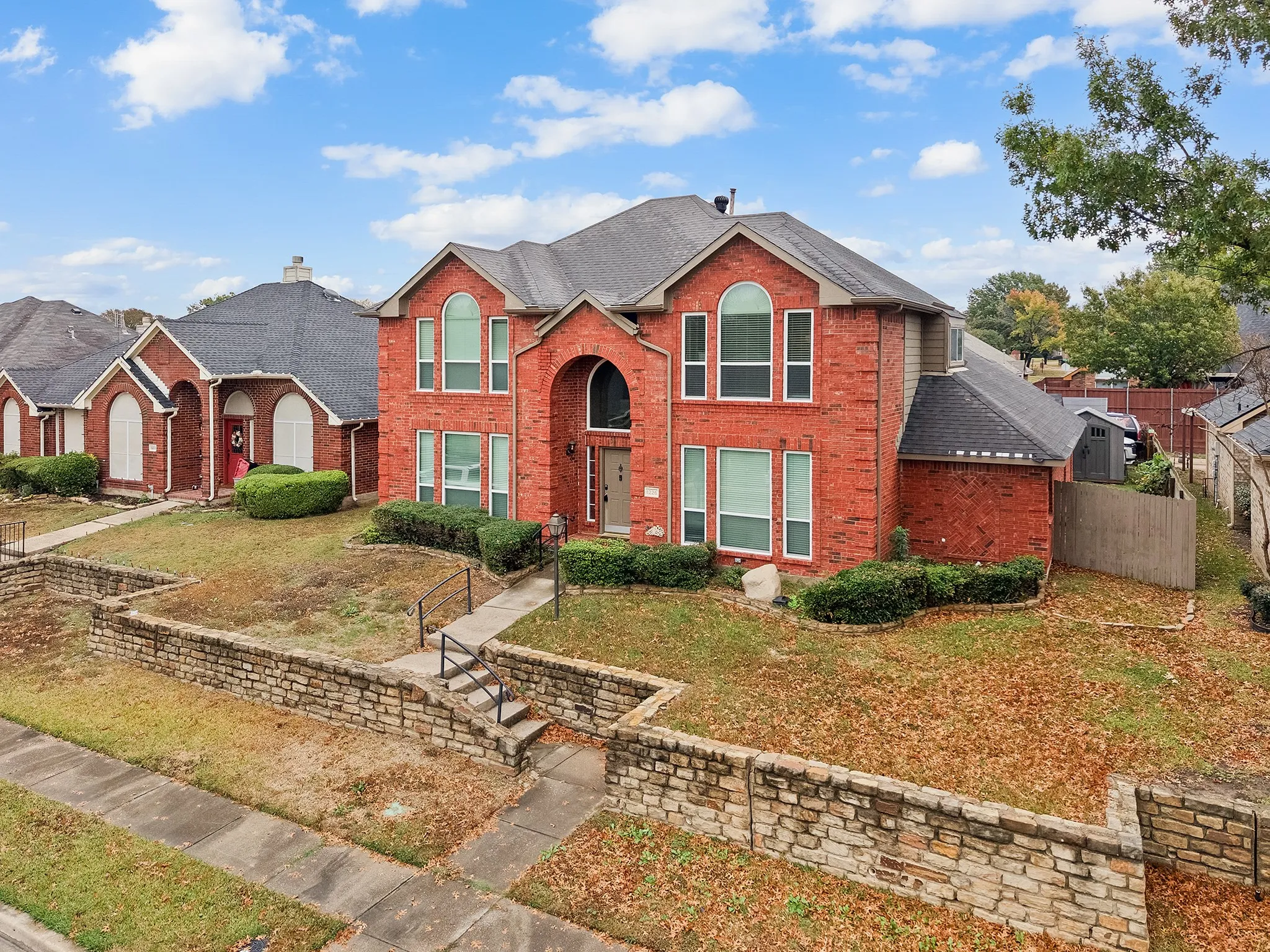 Traditional home with brick siding and a shingled roof