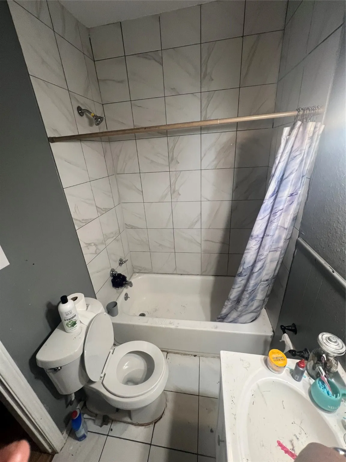 Bathroom featuring shower / tub combo with curtain, vanity, and tile patterned flooring