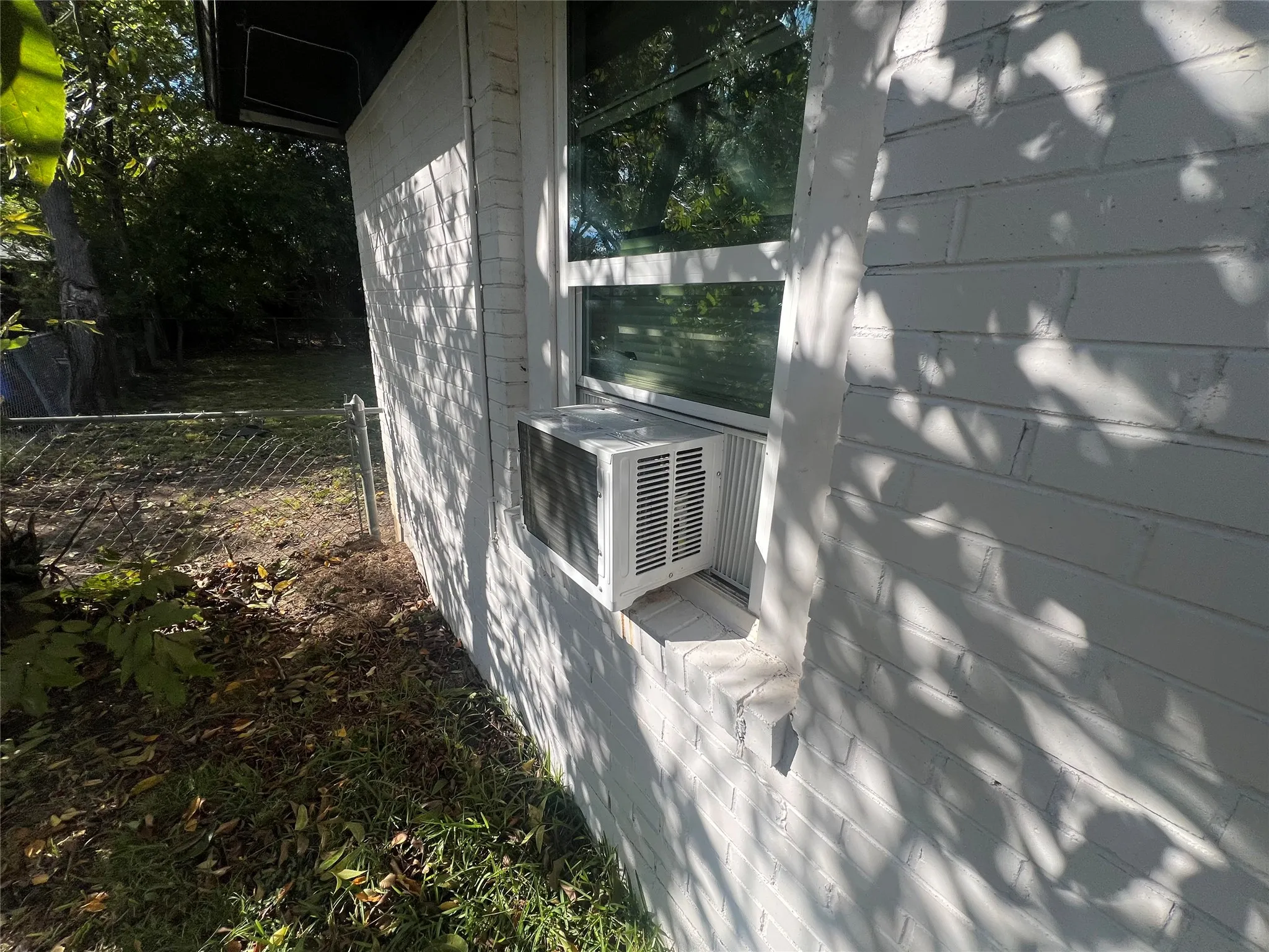 View of home's exterior with cooling unit