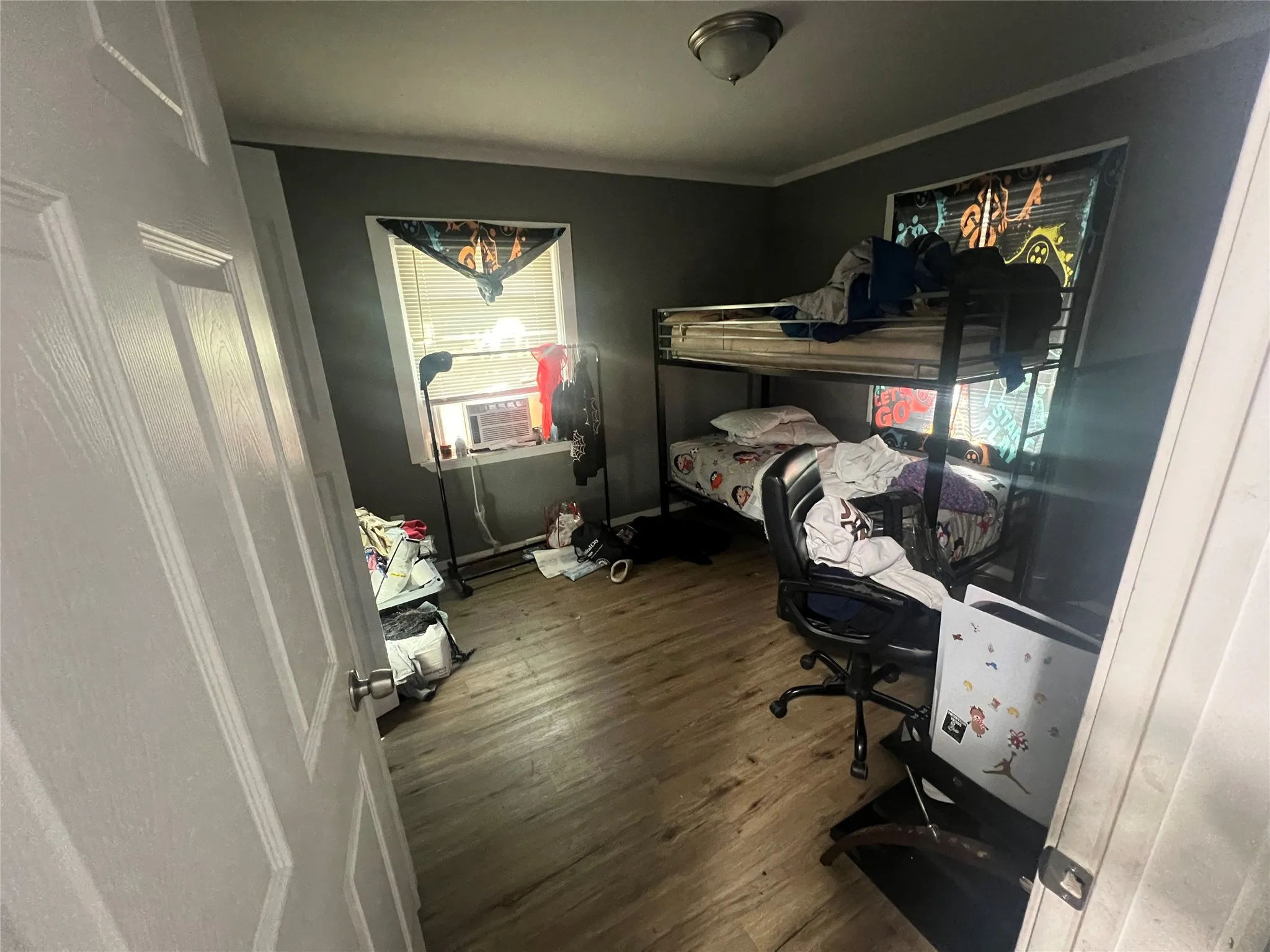 Bedroom featuring dark wood-type flooring and crown molding