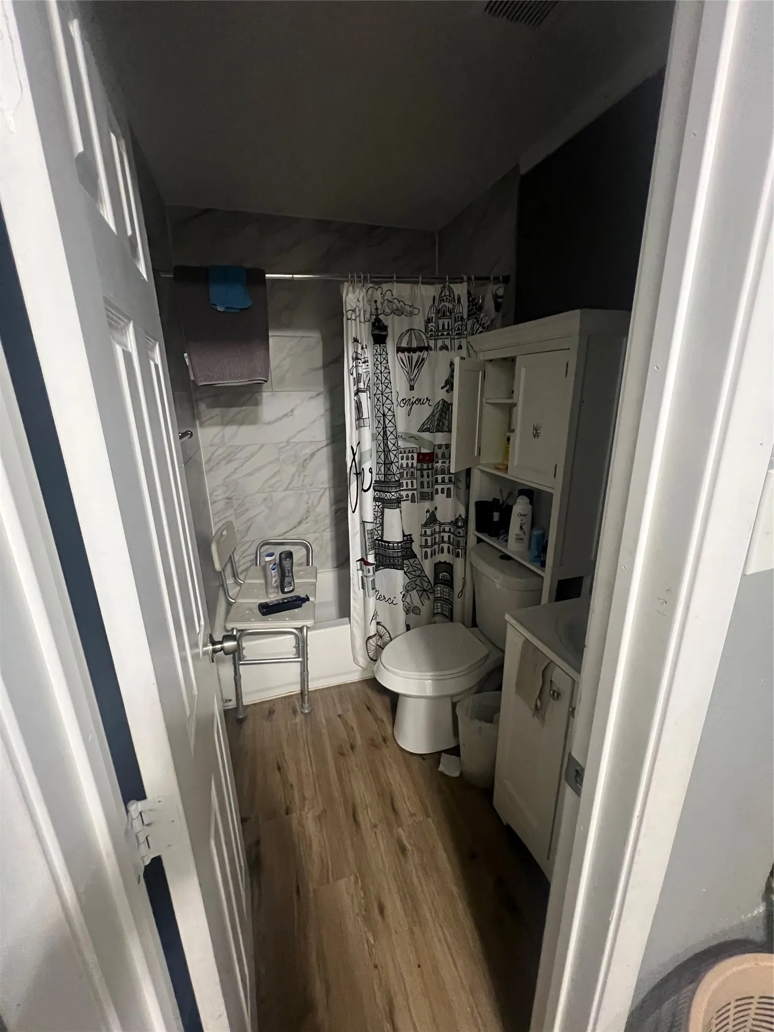 Bathroom featuring vanity, a shower with shower curtain, and dark wood finished floors