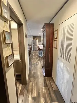 Corridor featuring dark wood-type flooring