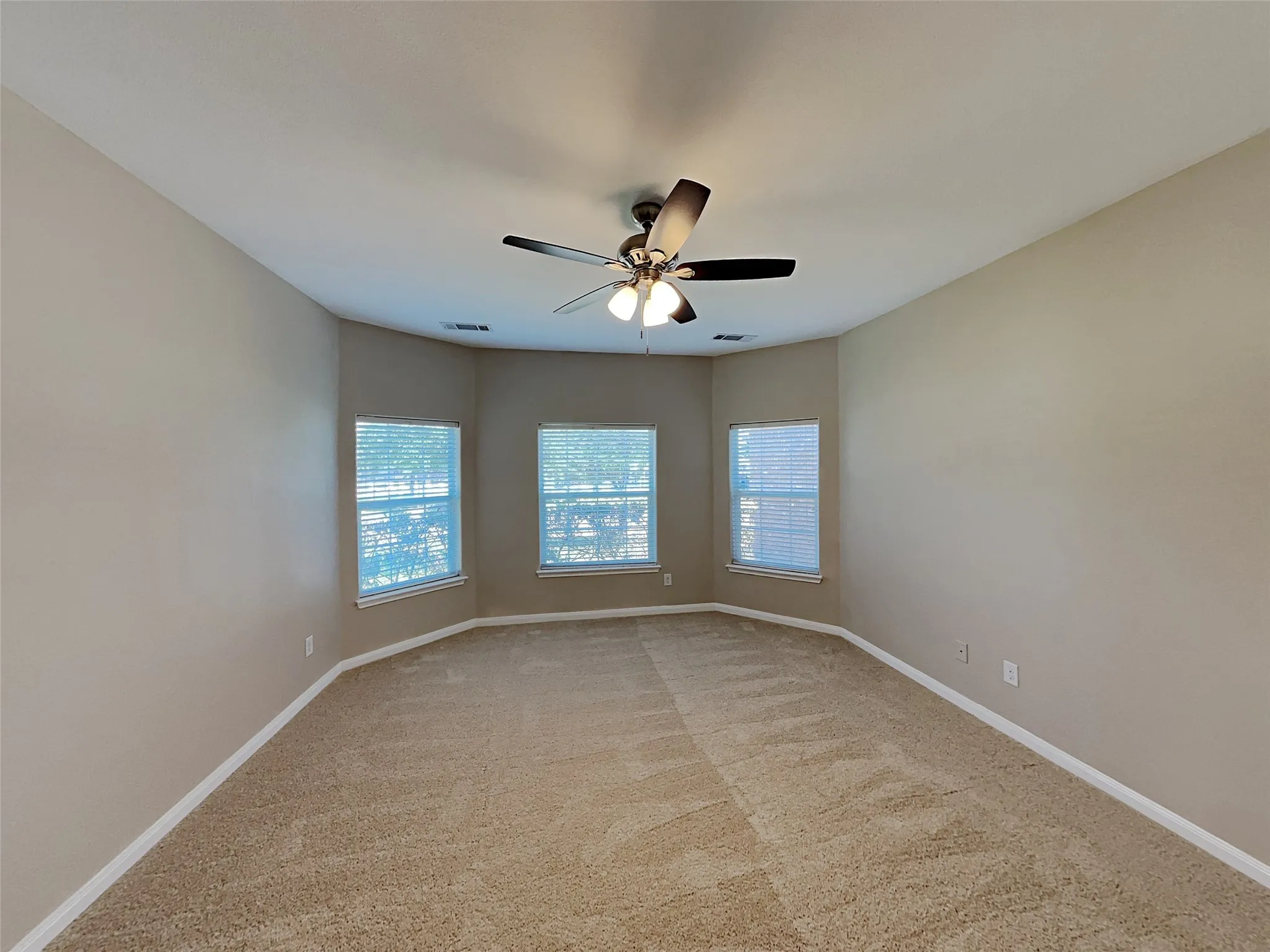 Spare room with light carpet and ceiling fan