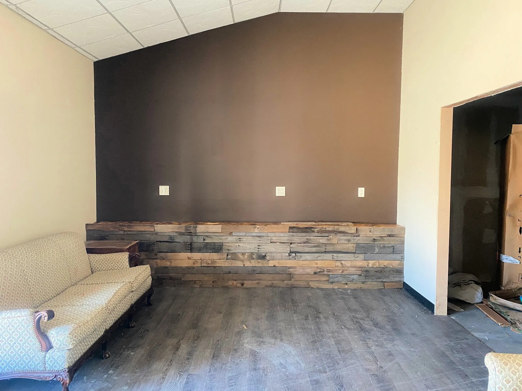 Living area with wood finished floors and a paneled ceiling