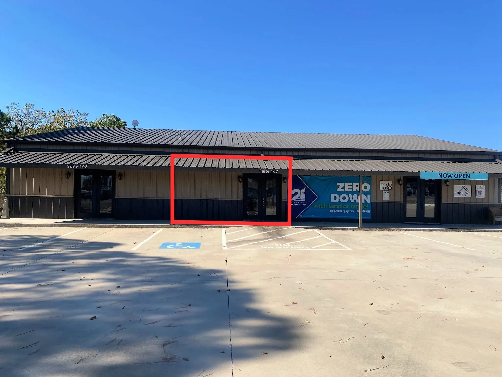 View of commercial property with uncovered parking