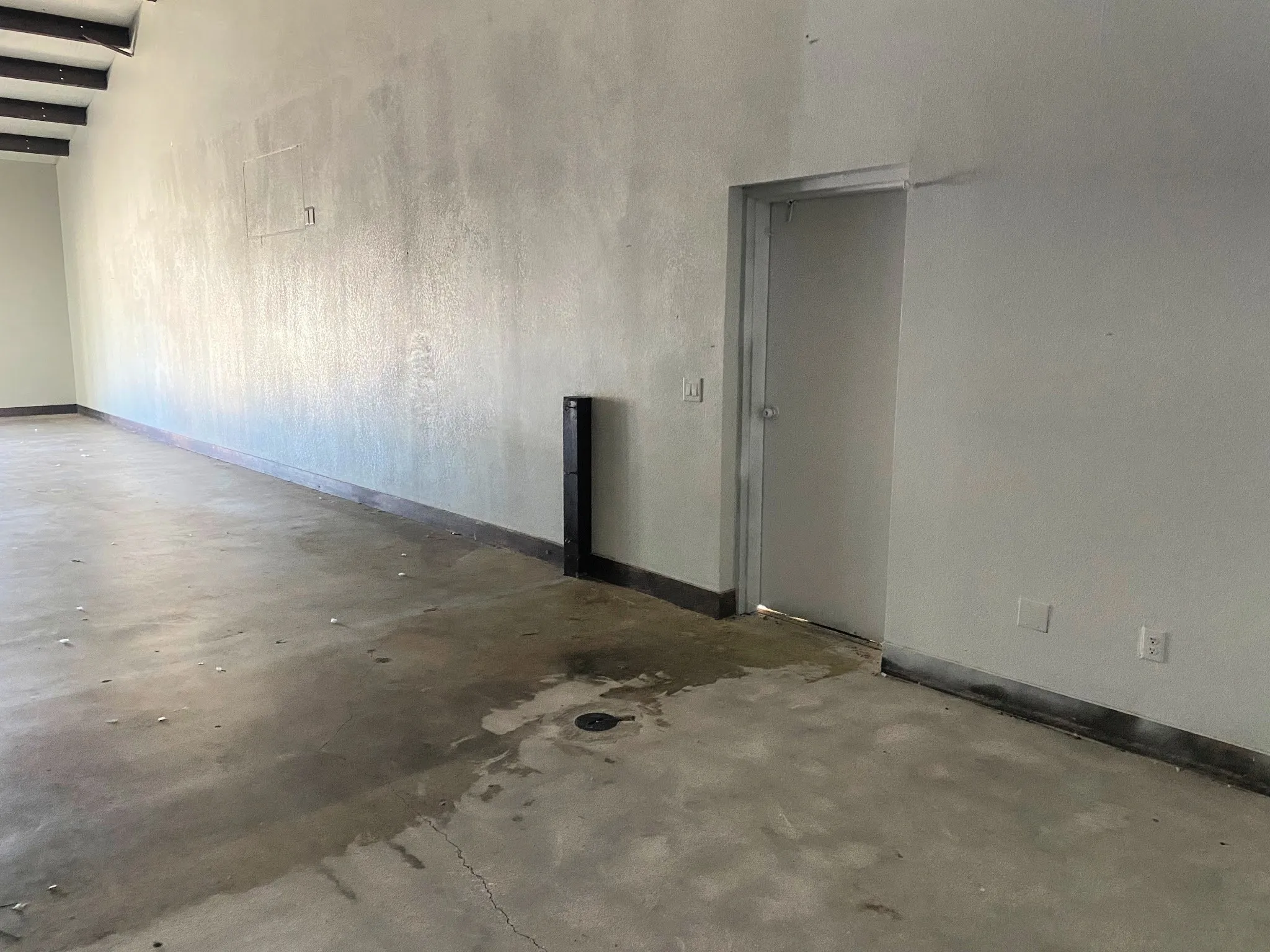Spare room featuring baseboards and concrete flooring