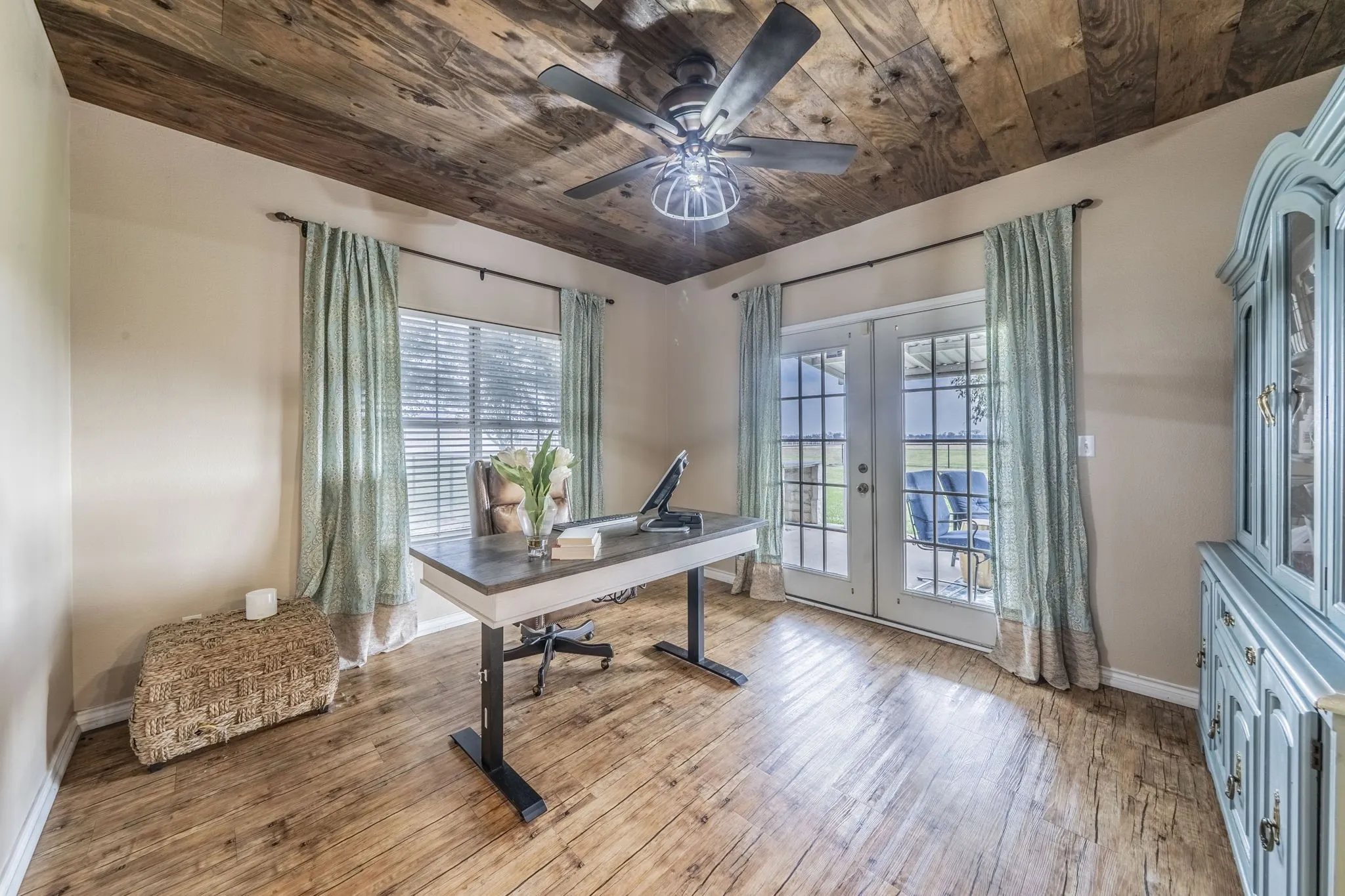 Dining room or office with double doors leading to large covered back patio