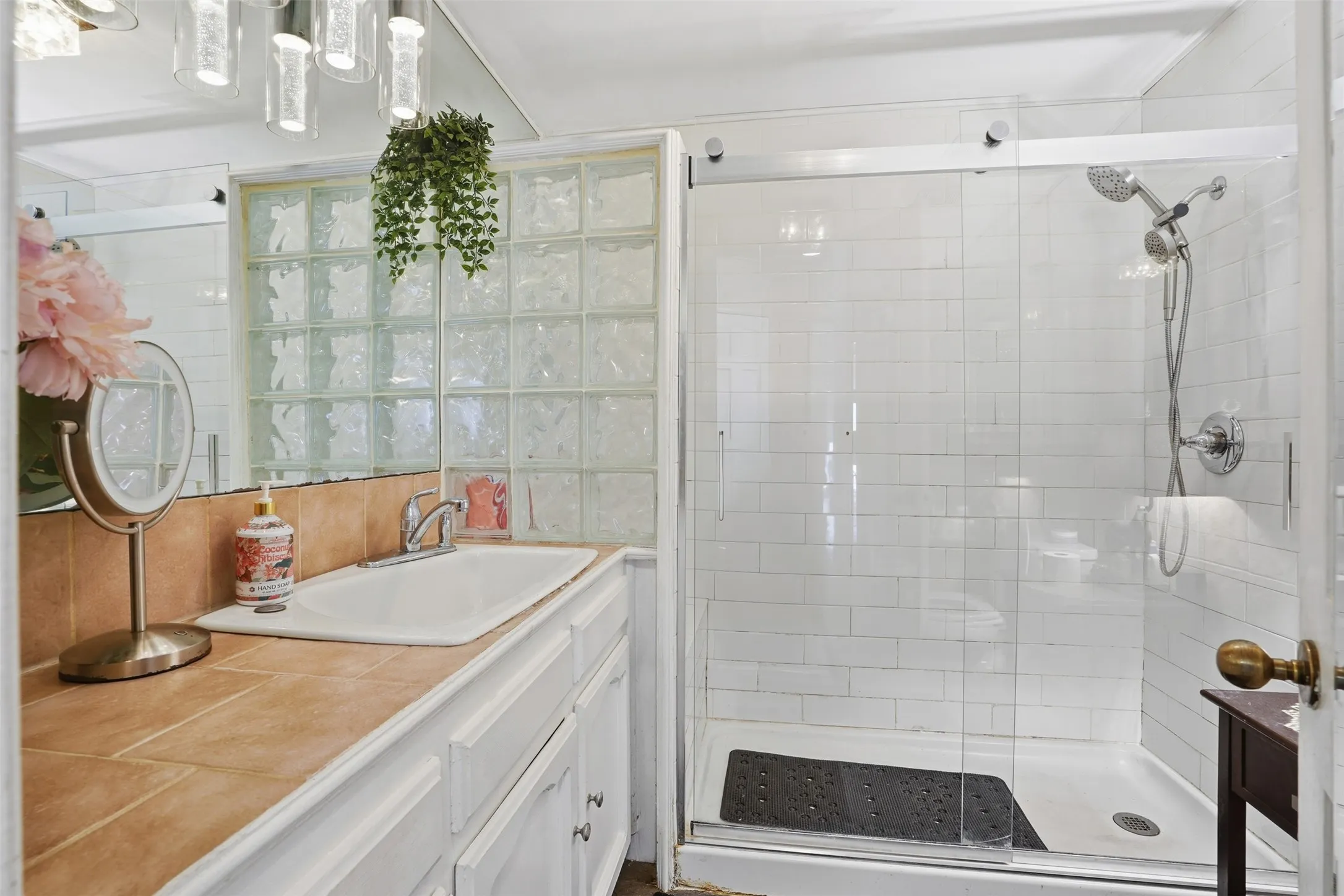 Bathroom with vanity and a stall shower