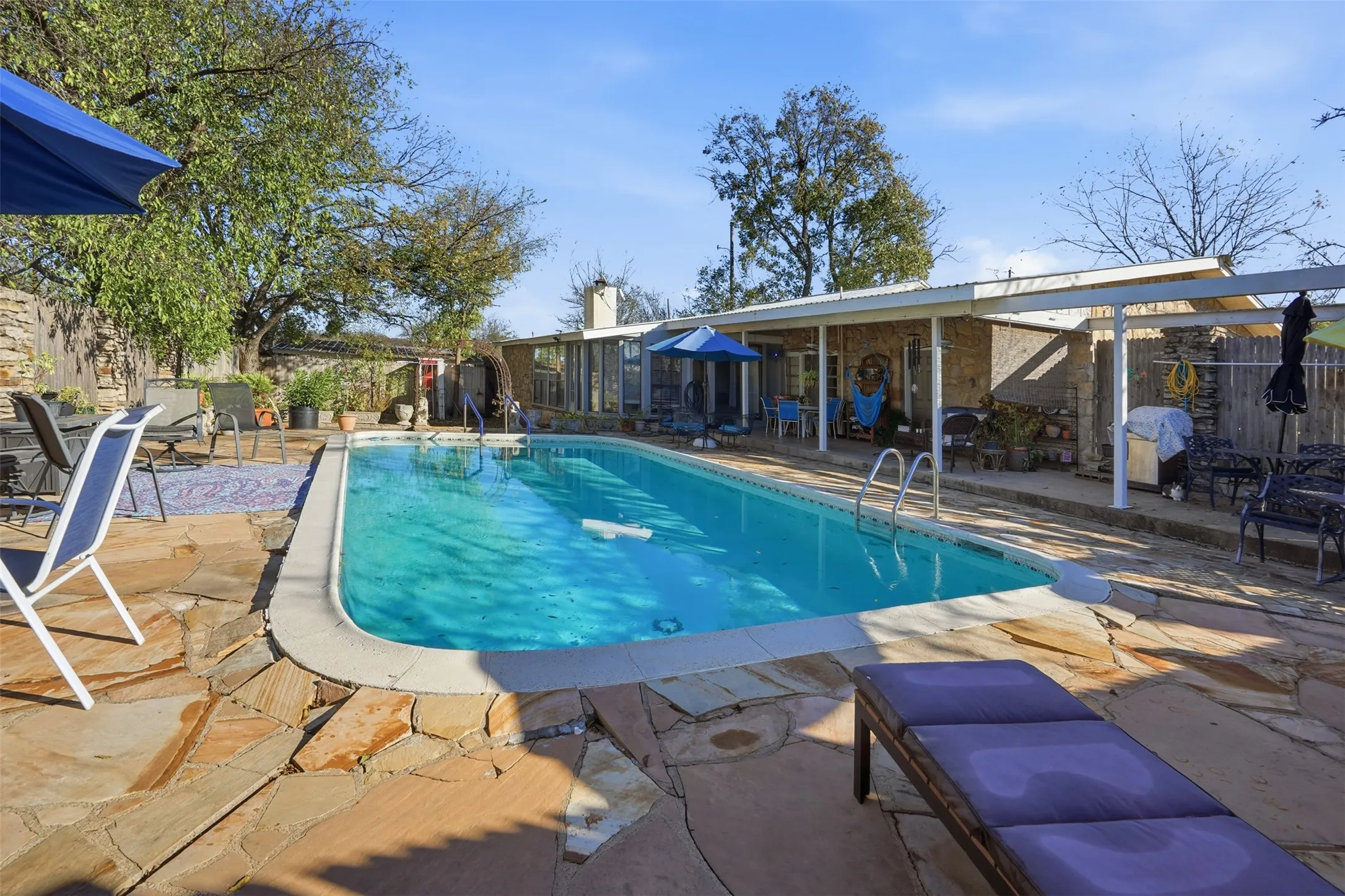 View of swimming pool featuring a patio, a fenced backyard, and a grill