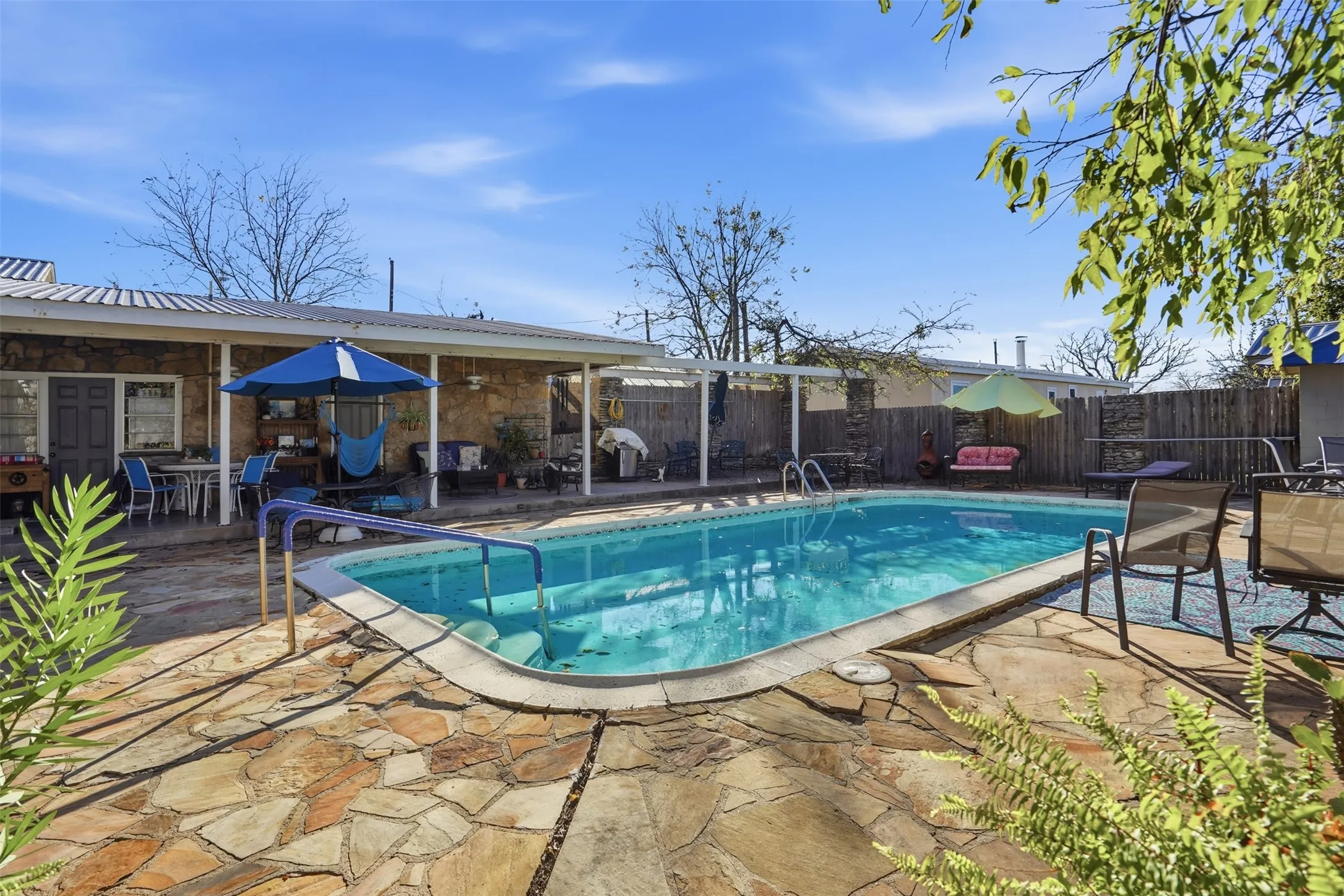 View of swimming pool with a patio, a fenced backyard, and outdoor dining space