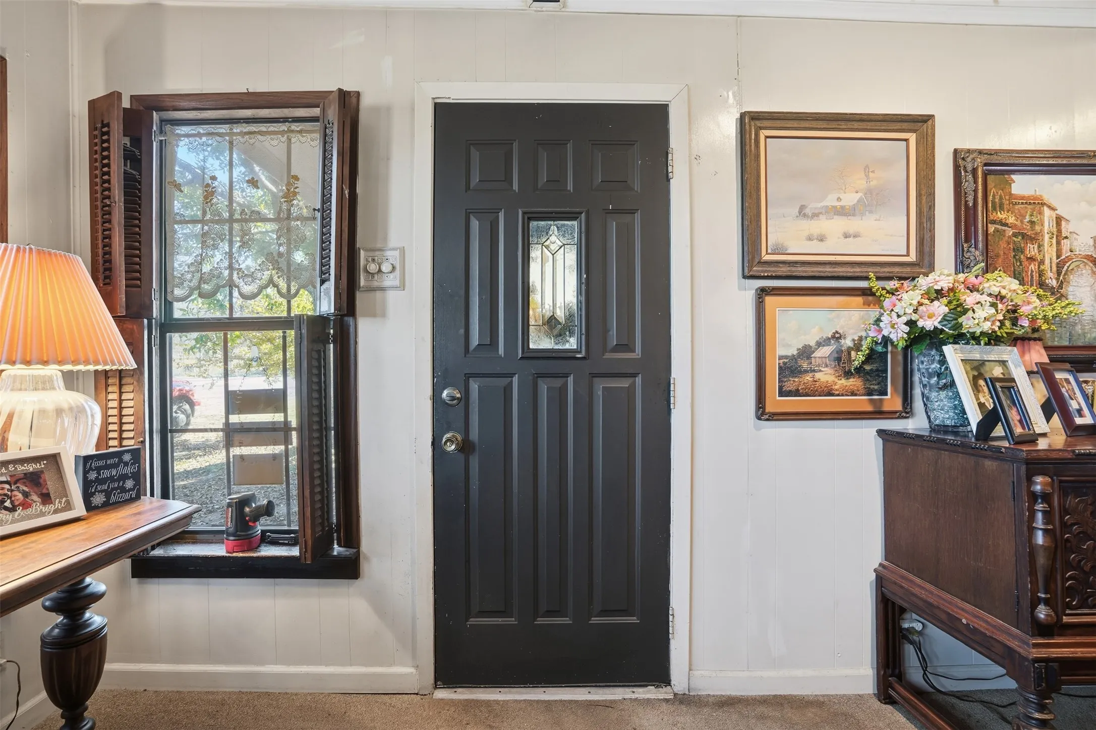 Foyer entrance featuring baseboards and a decorative wall