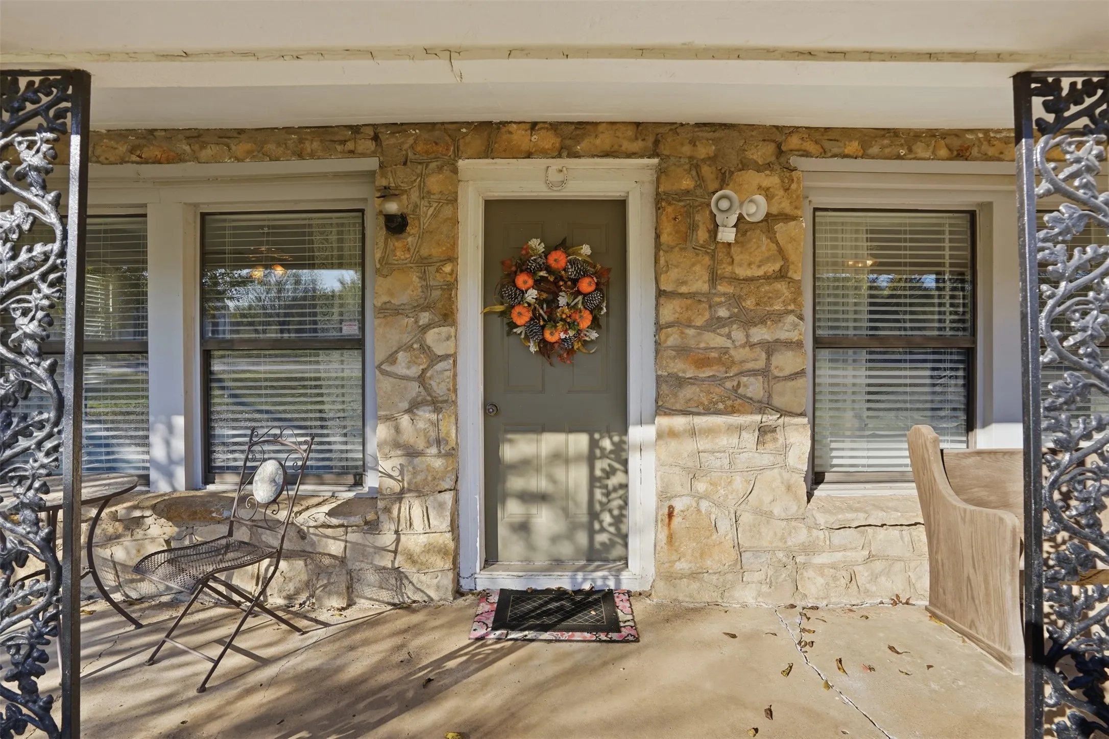 Property entrance featuring stone siding and covered porch