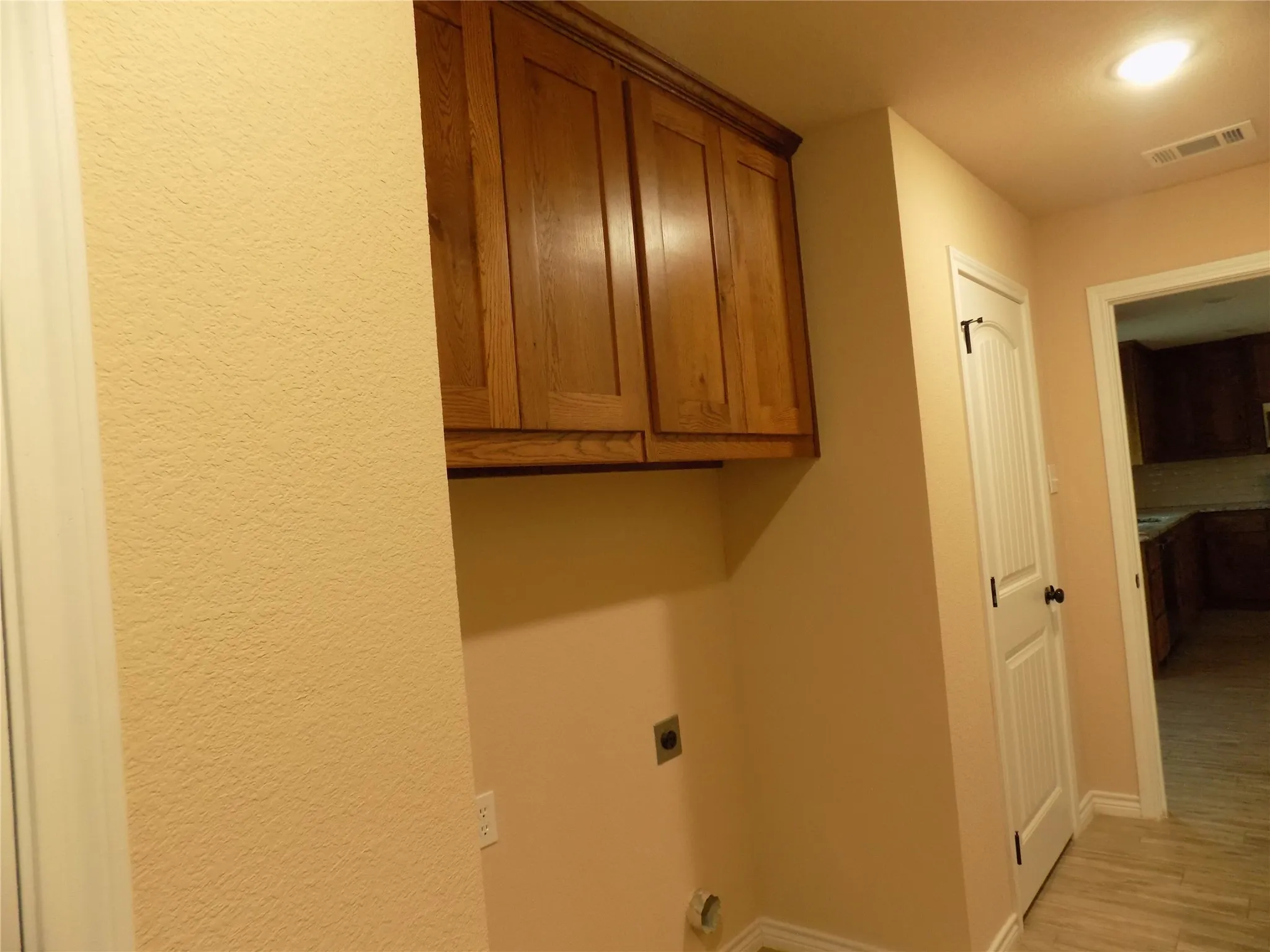 Wonderful cabinet space in laundry room. Pantry door showing just as you enter kitchen.