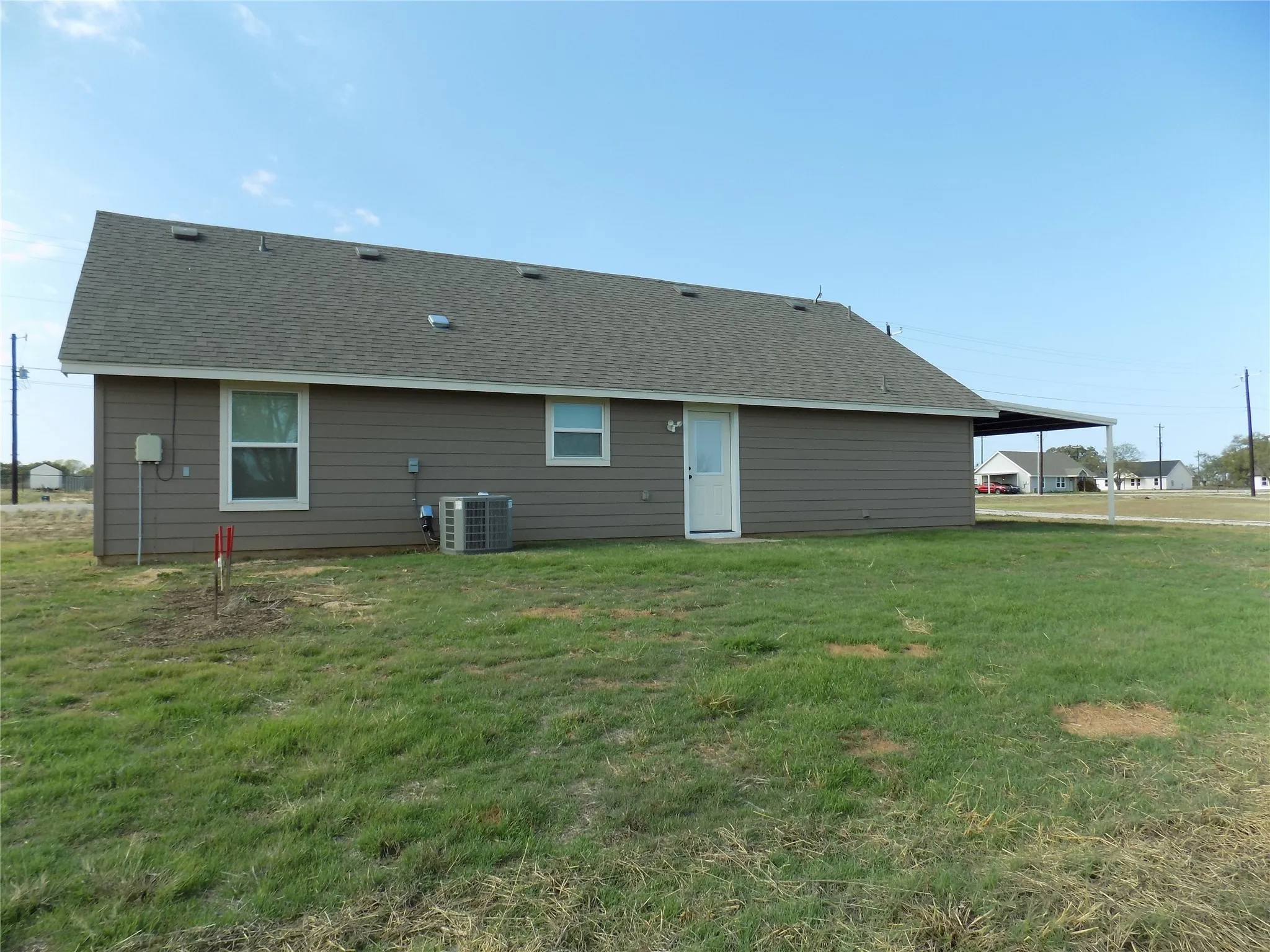 Back of property with view of large back yard.