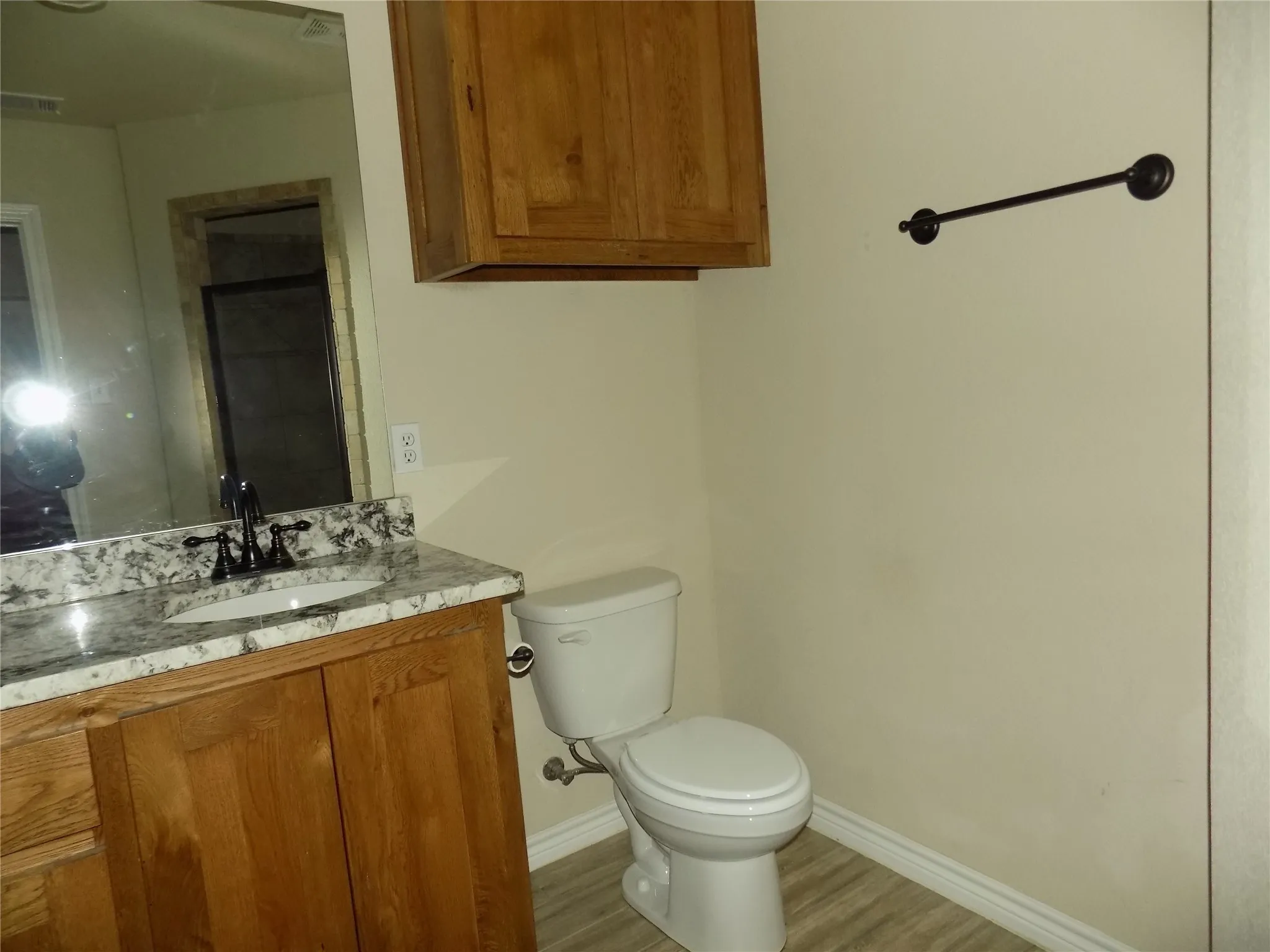 View of cabinet over toilet, a plus in a bathroom.