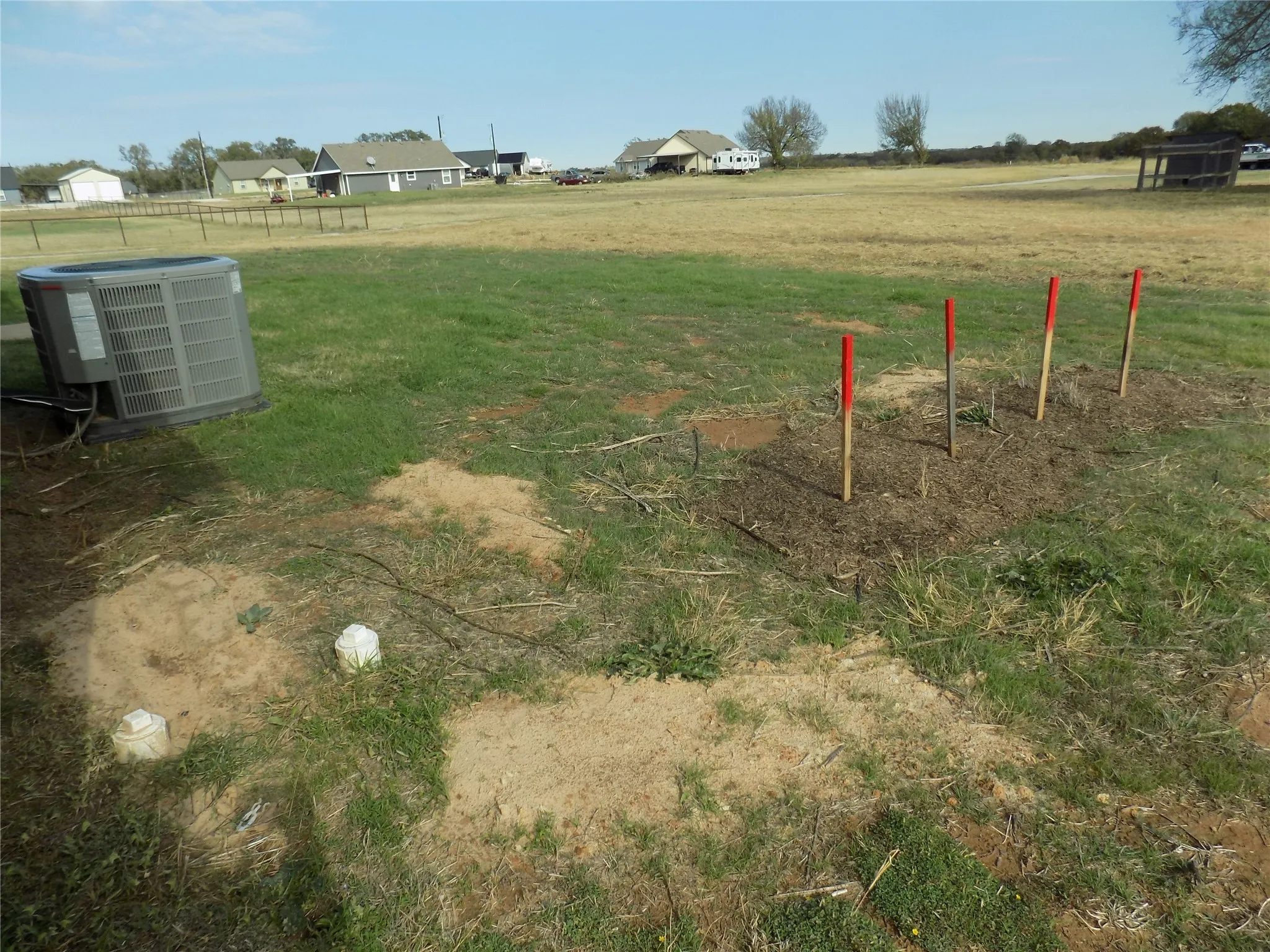 View of yard at the septic tank area at the back corner of home. No question of location.