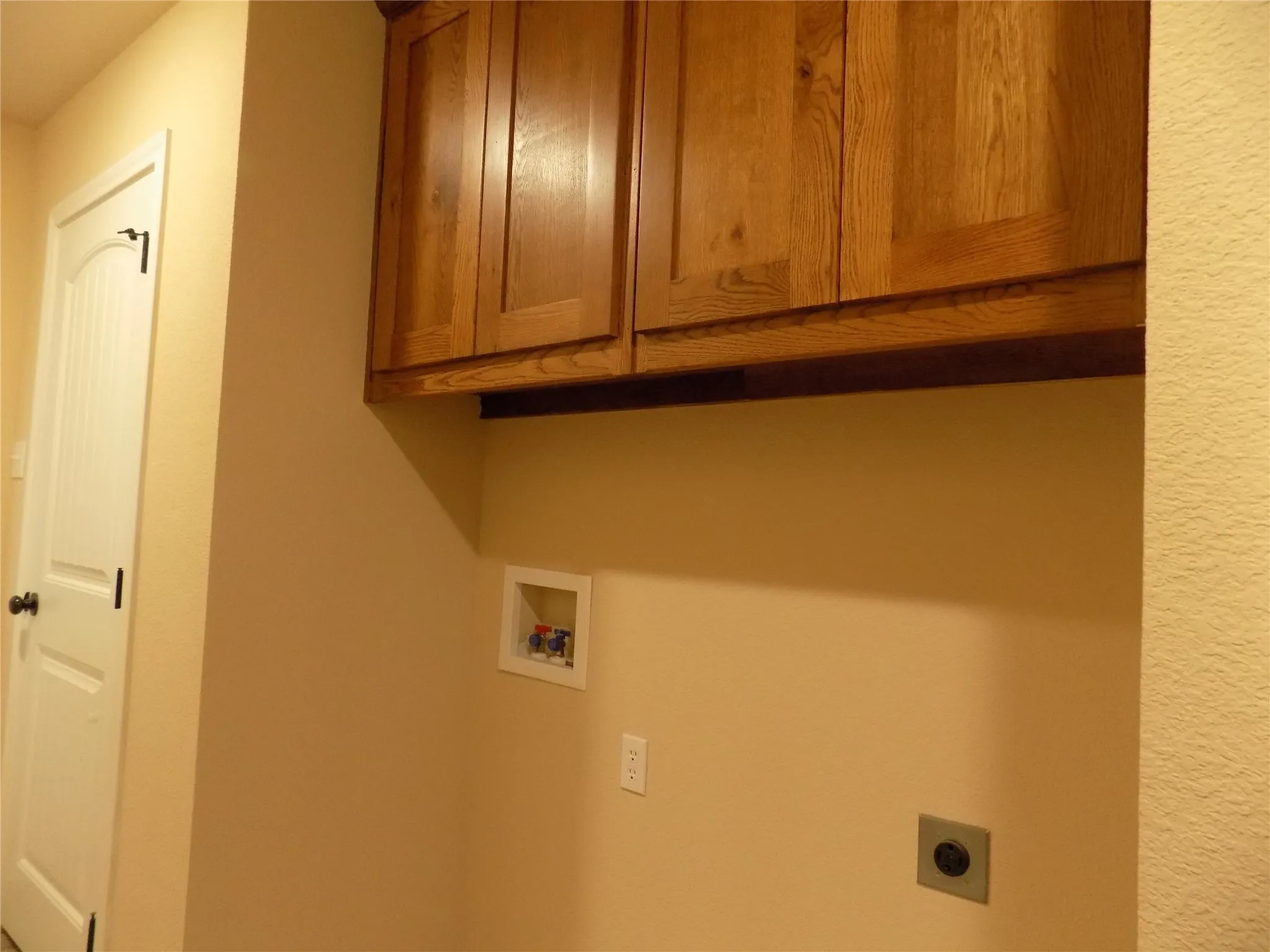 Laundry area featuring cabinet space, washer hookup, and hookup for an electric dryer