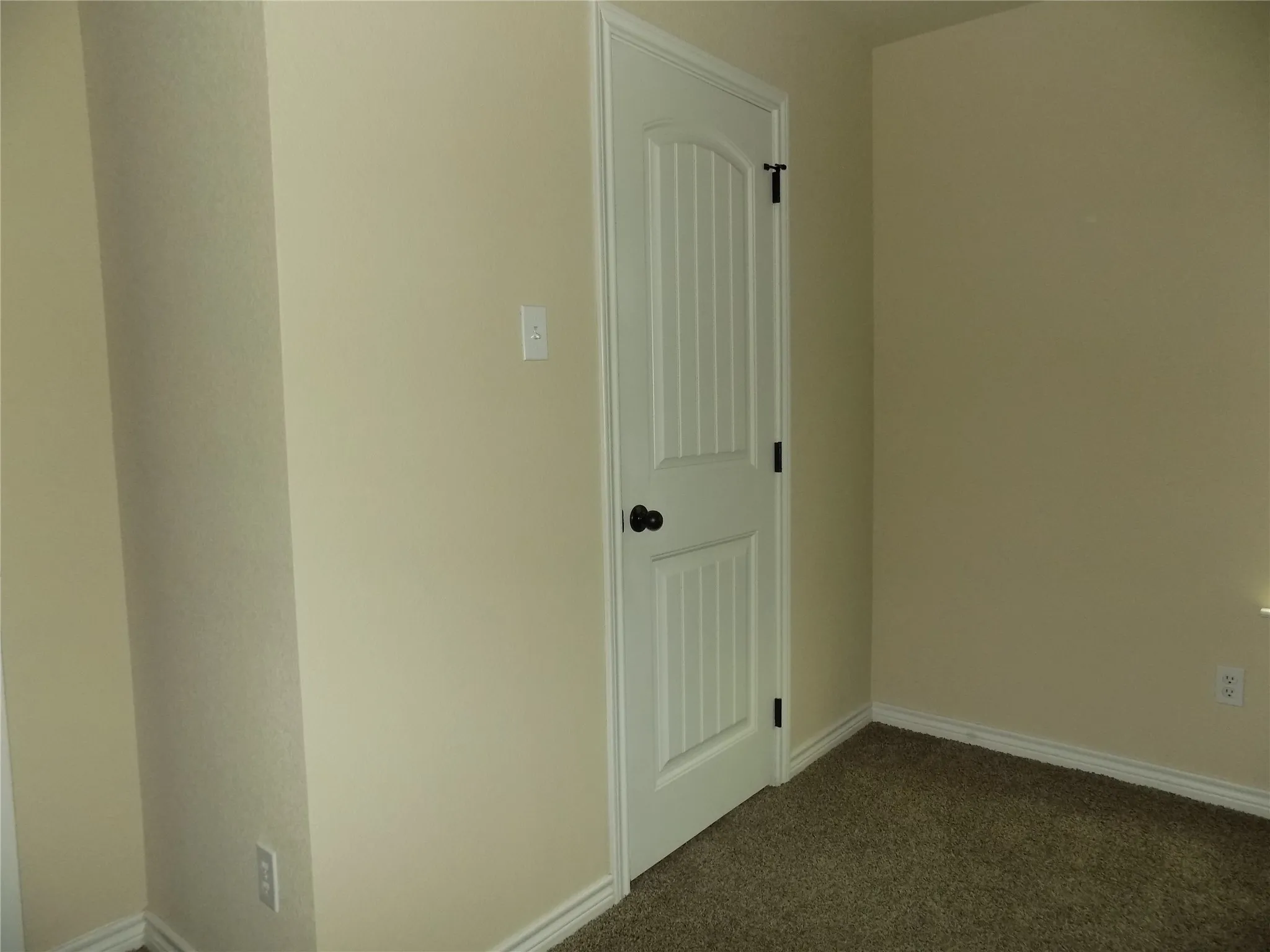 Bedroom featuring a large walk in closet, with custom designed door, which is used throughout the home.