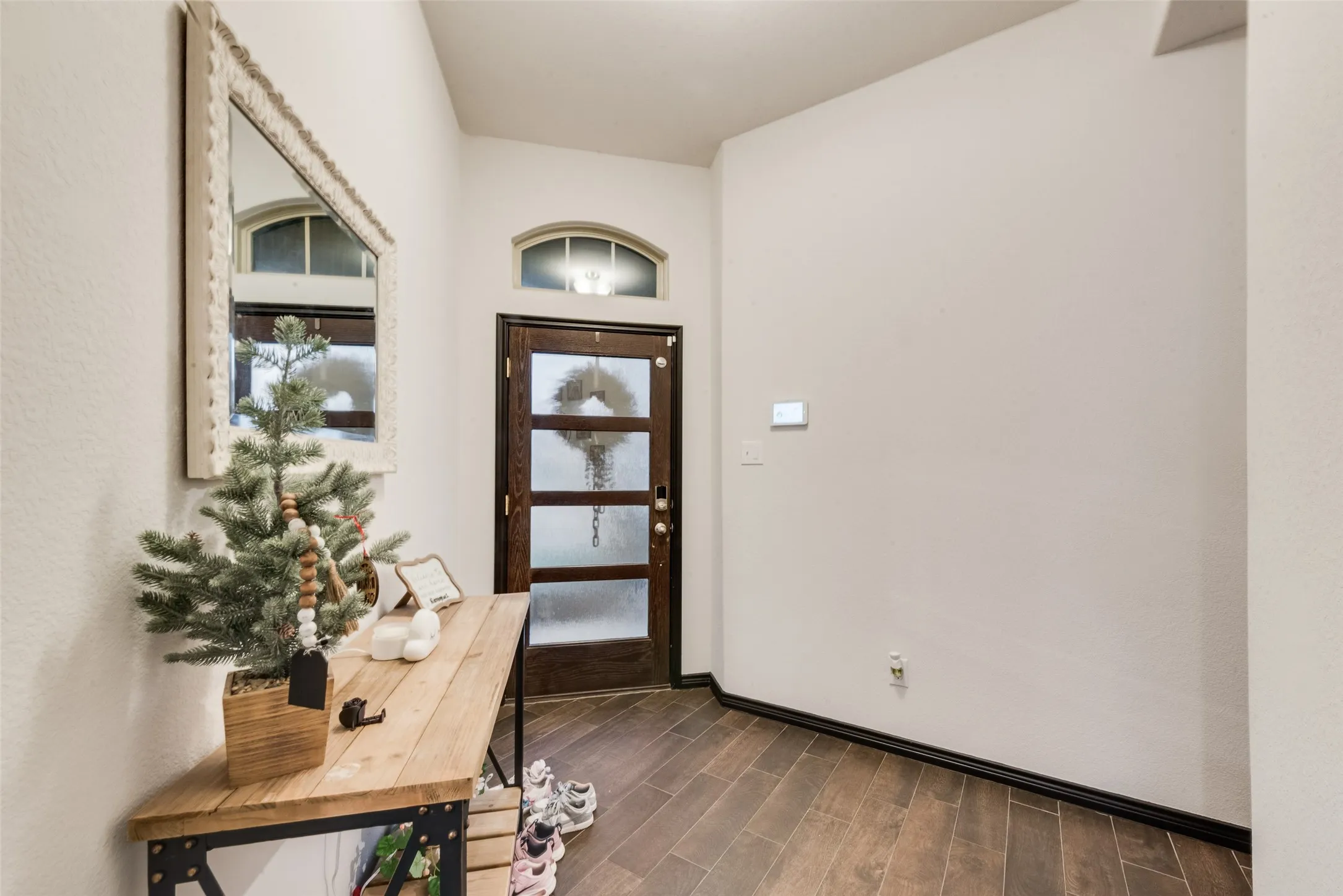 Entrance foyer with wood finish floors and baseboards