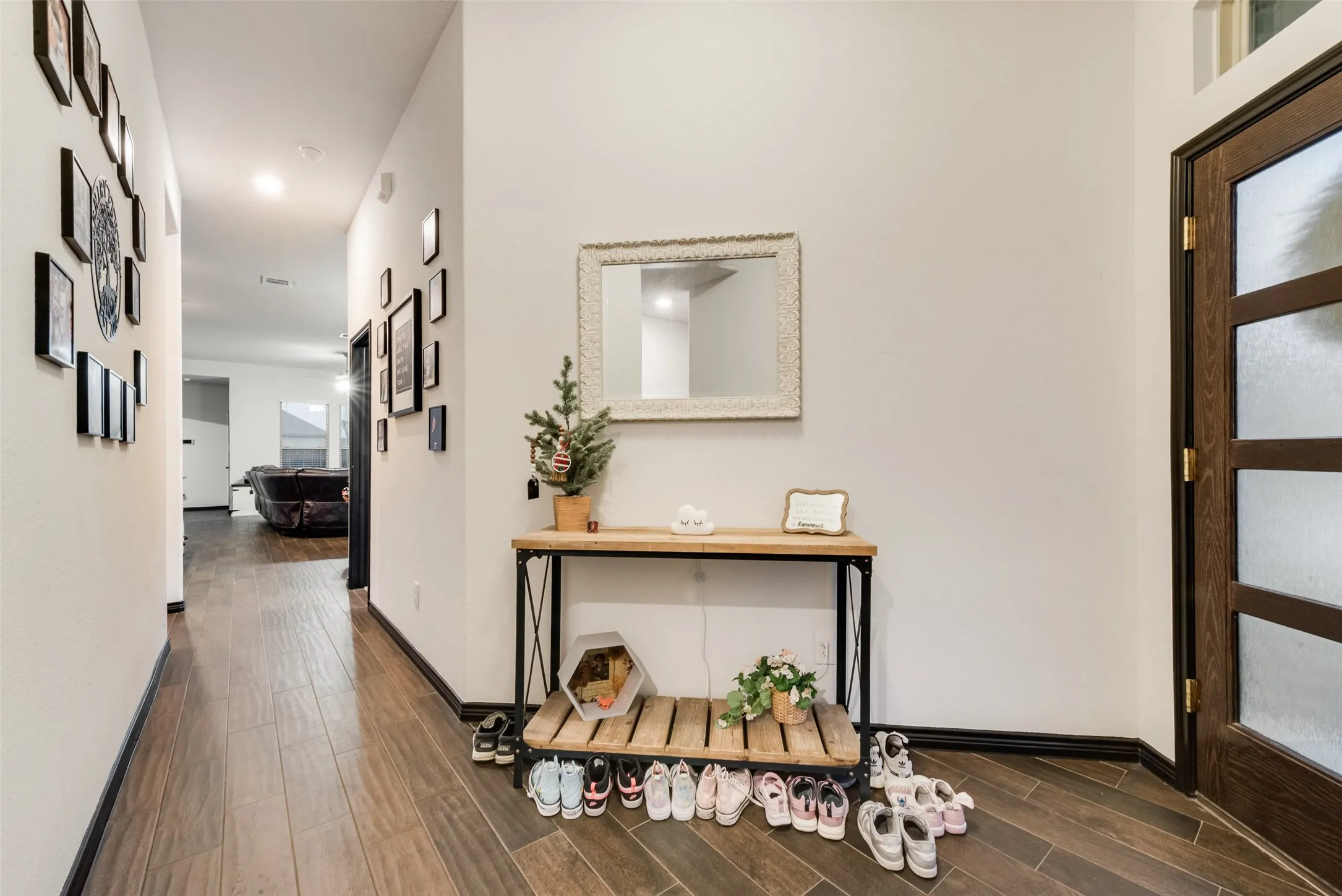 Hallway with wood tiled floors and recessed lighting