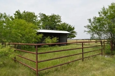 Gate with an outdoor structure, a view of countryside, and an exterior structure