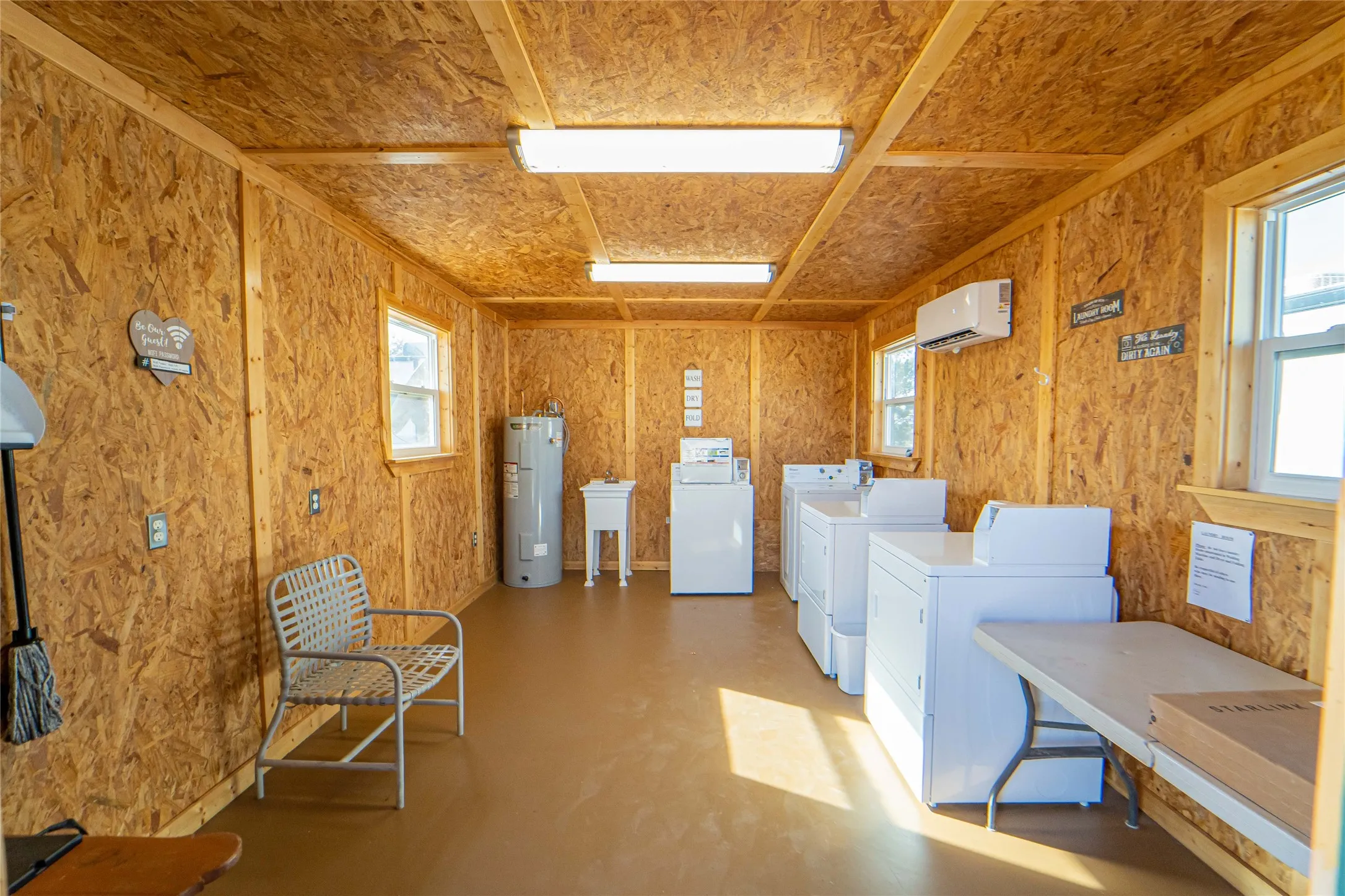 Community laundry room with water heater and washer and dryer