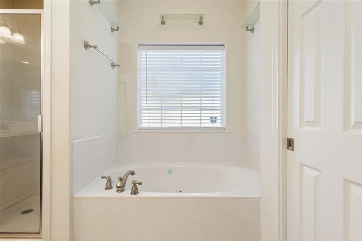 Bathroom with a stall shower and a bath