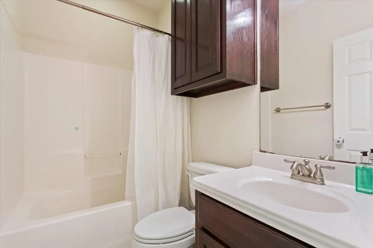 Bathroom featuring vanity and shower / tub combo