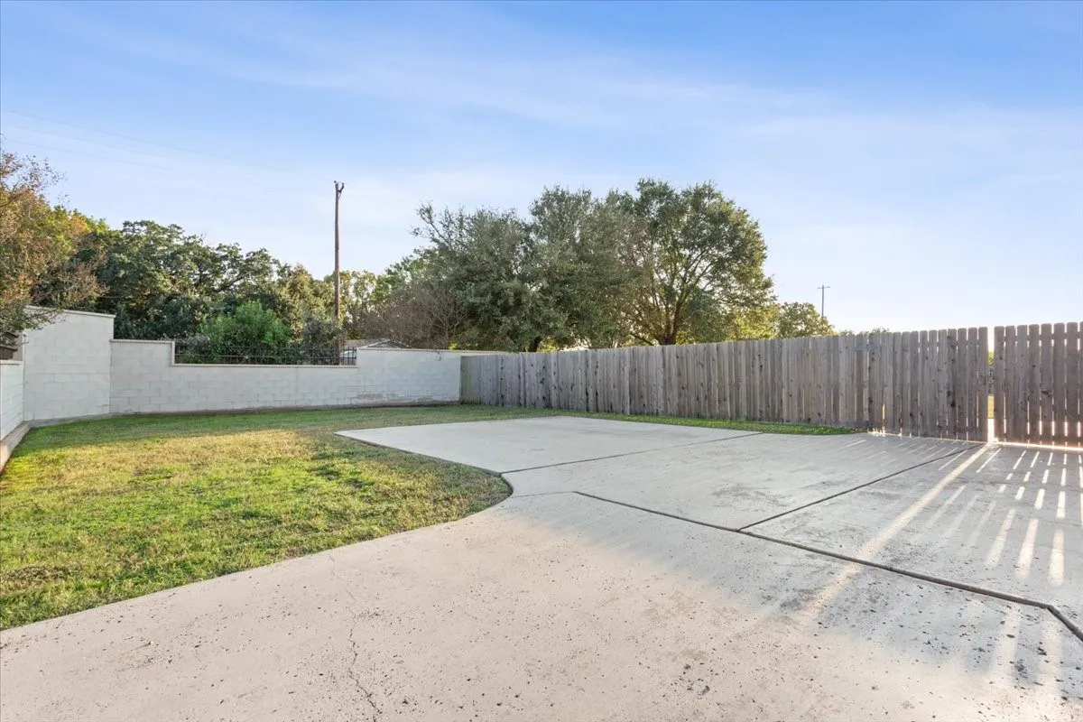 Fenced backyard with a patio area