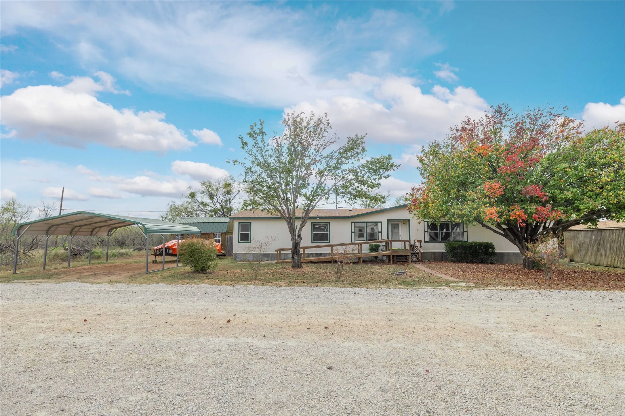 Manufactured / mobile home with a deck and a detached carport