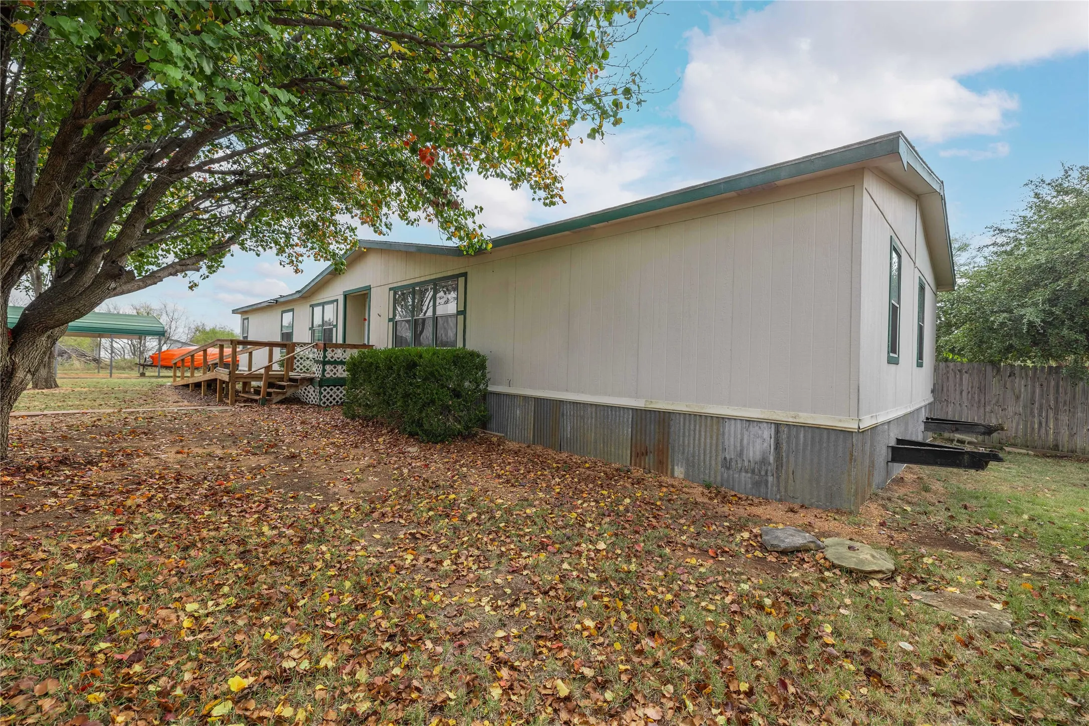 View of property exterior with a wooden deck