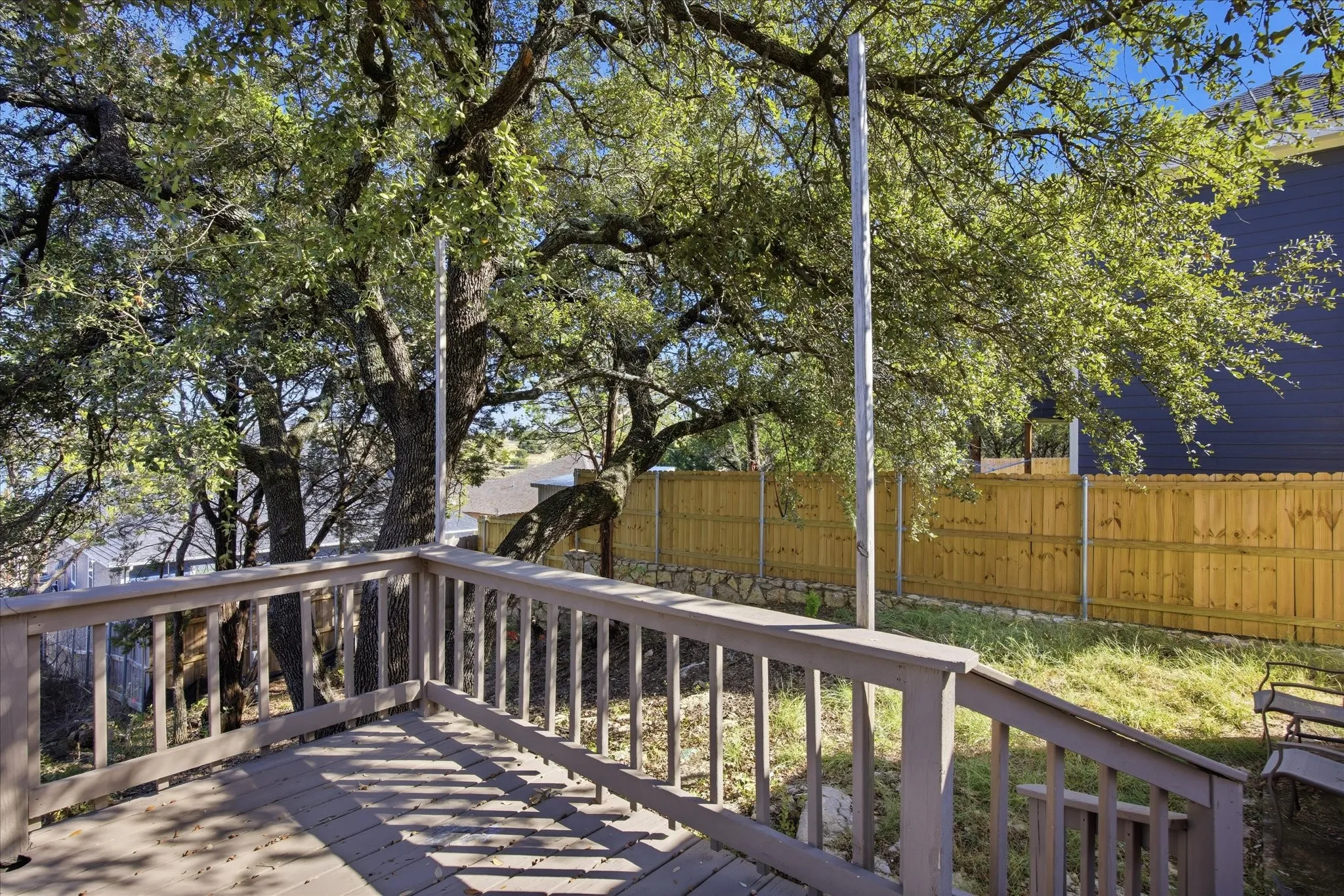 Wooden deck featuring a fenced backyard