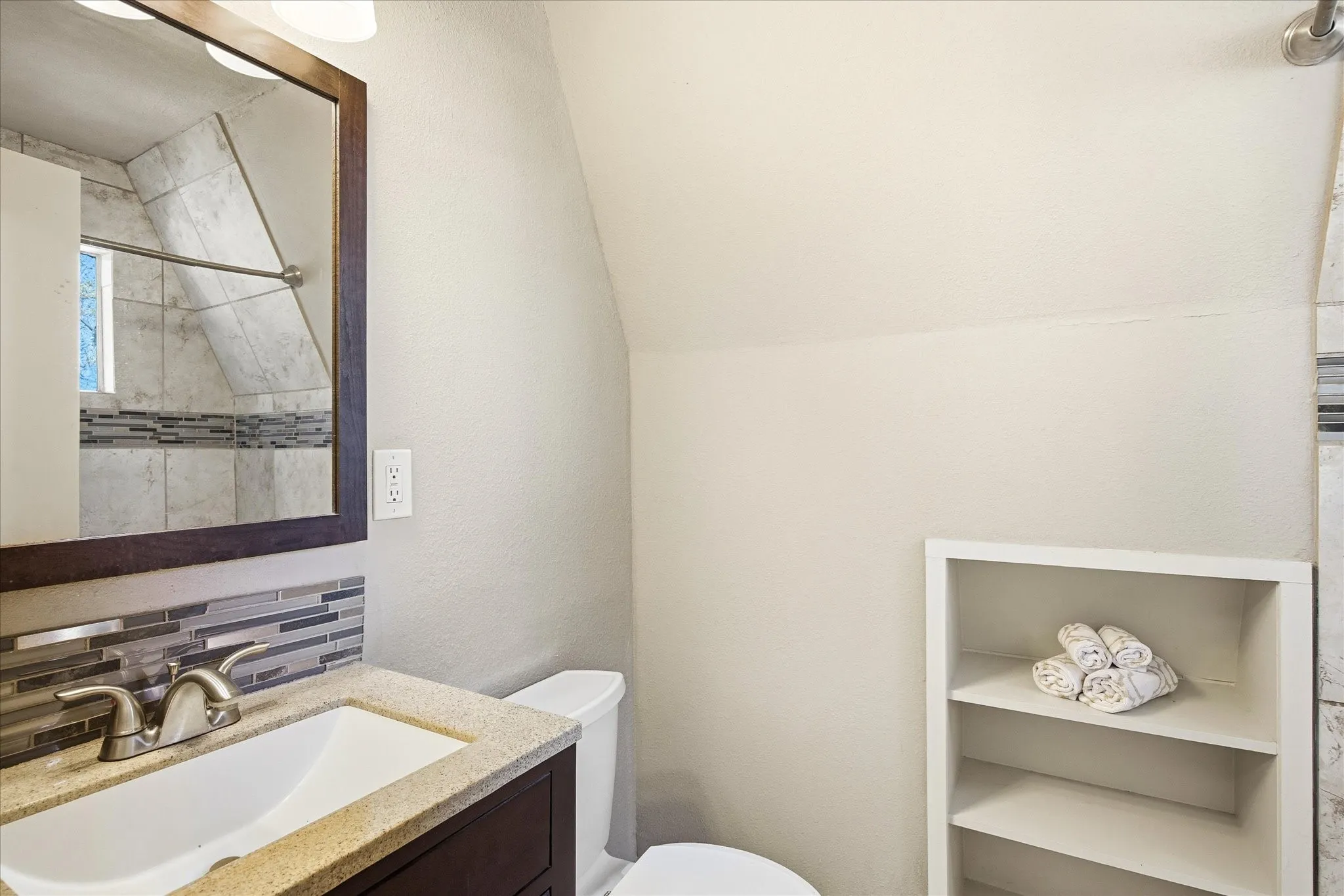 Primary Bathroom featuring decorative backsplash, vanity and a tub