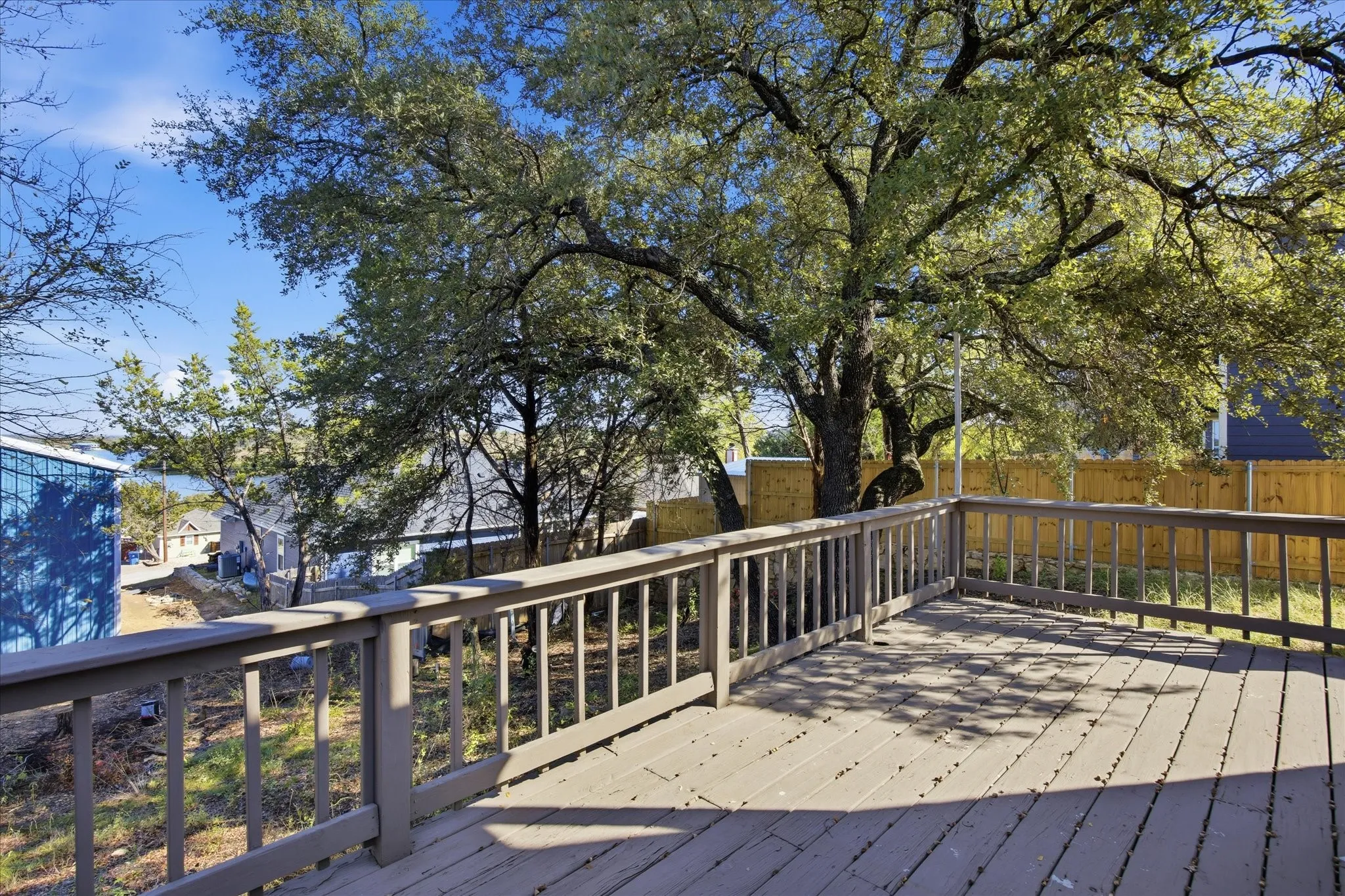 Wooden deck featuring a fenced backyard