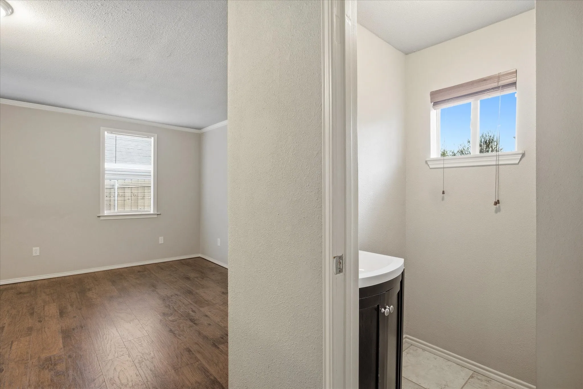 Bathroom featuring vanity, hardwood / wood-style floors and a textured ceiling