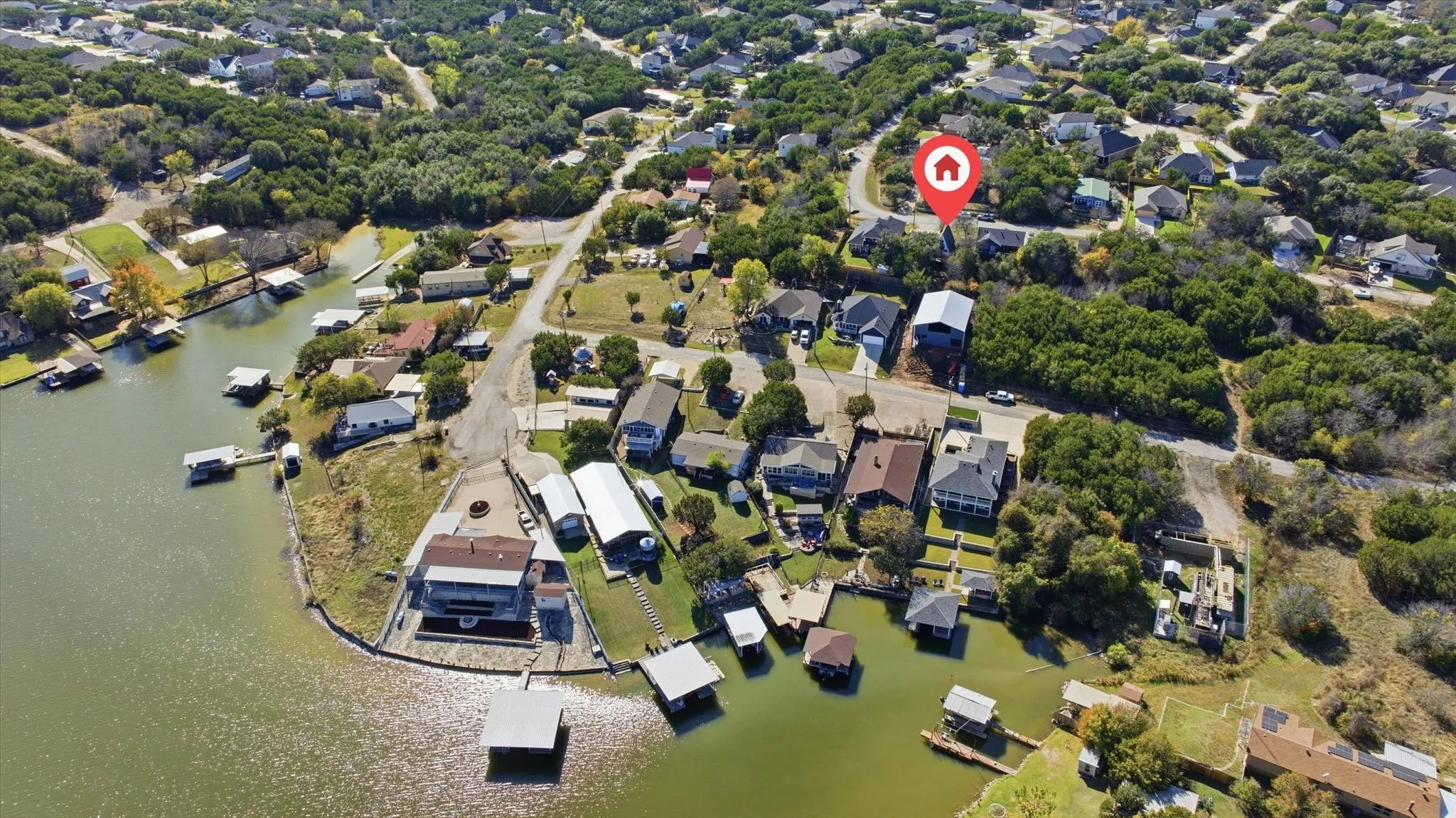 Aerial view of property and surrounding area with nearby suburban area and a nearby body of water
