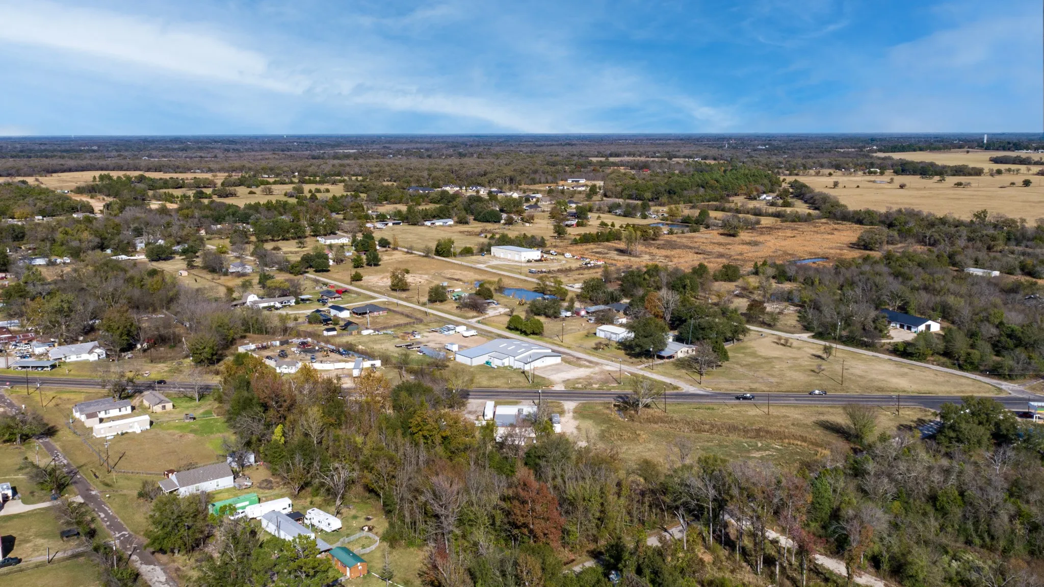 Aerial overview of property's location featuring a tree filled landscape