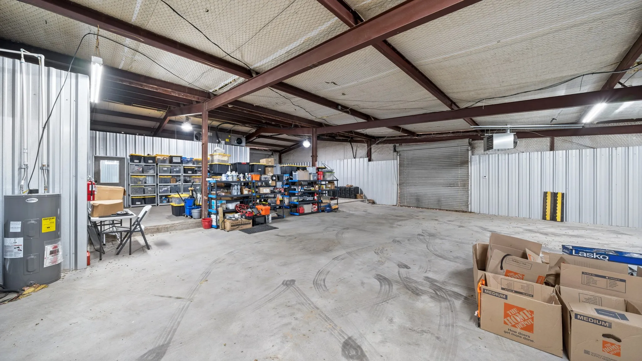Garage with water heater and metal wall