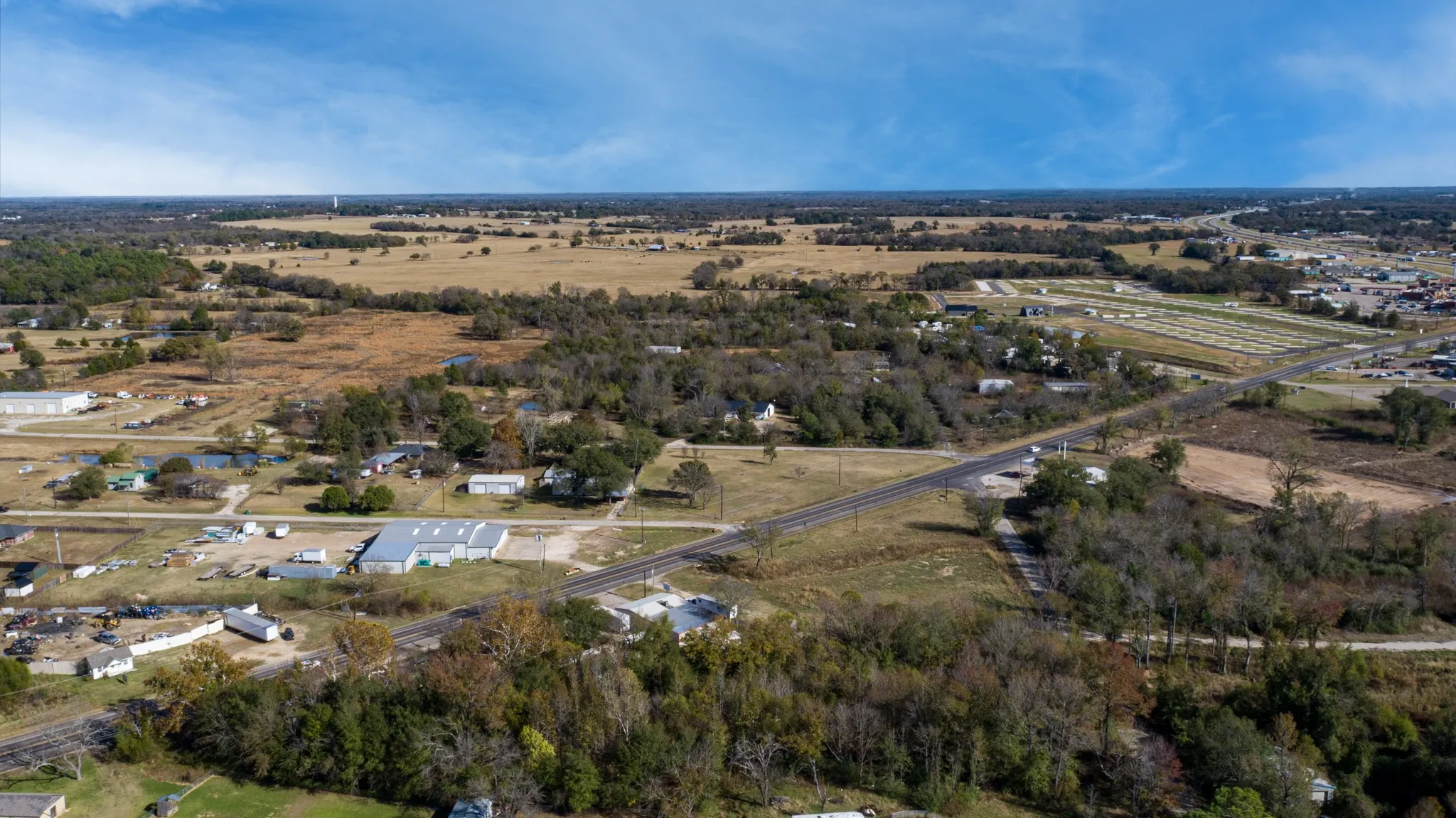 Aerial view of property's location featuring a tree filled landscape and rural landscape