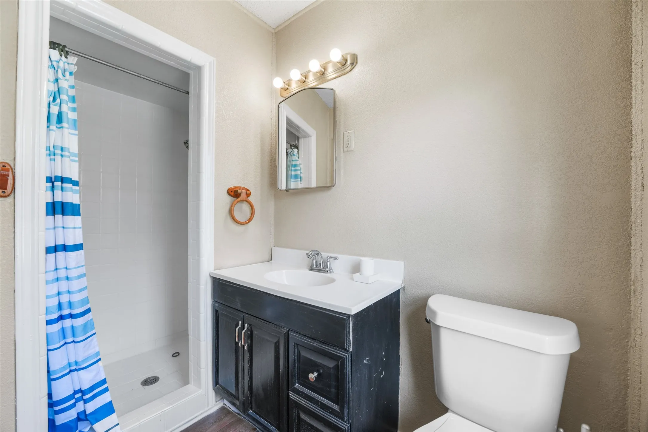 Bathroom featuring a stall shower and vanity