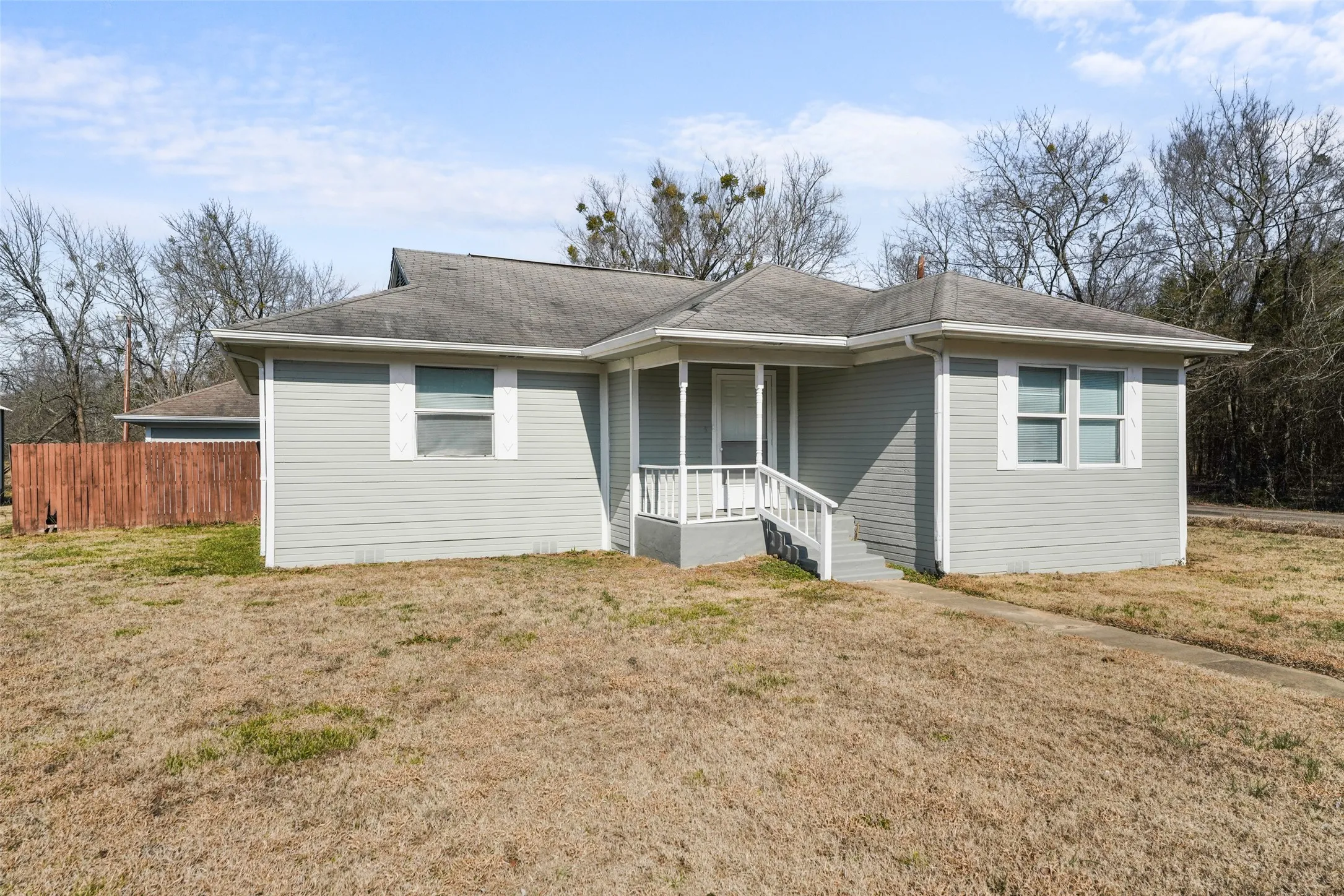 View of front of house with roof with shingles and covered porch