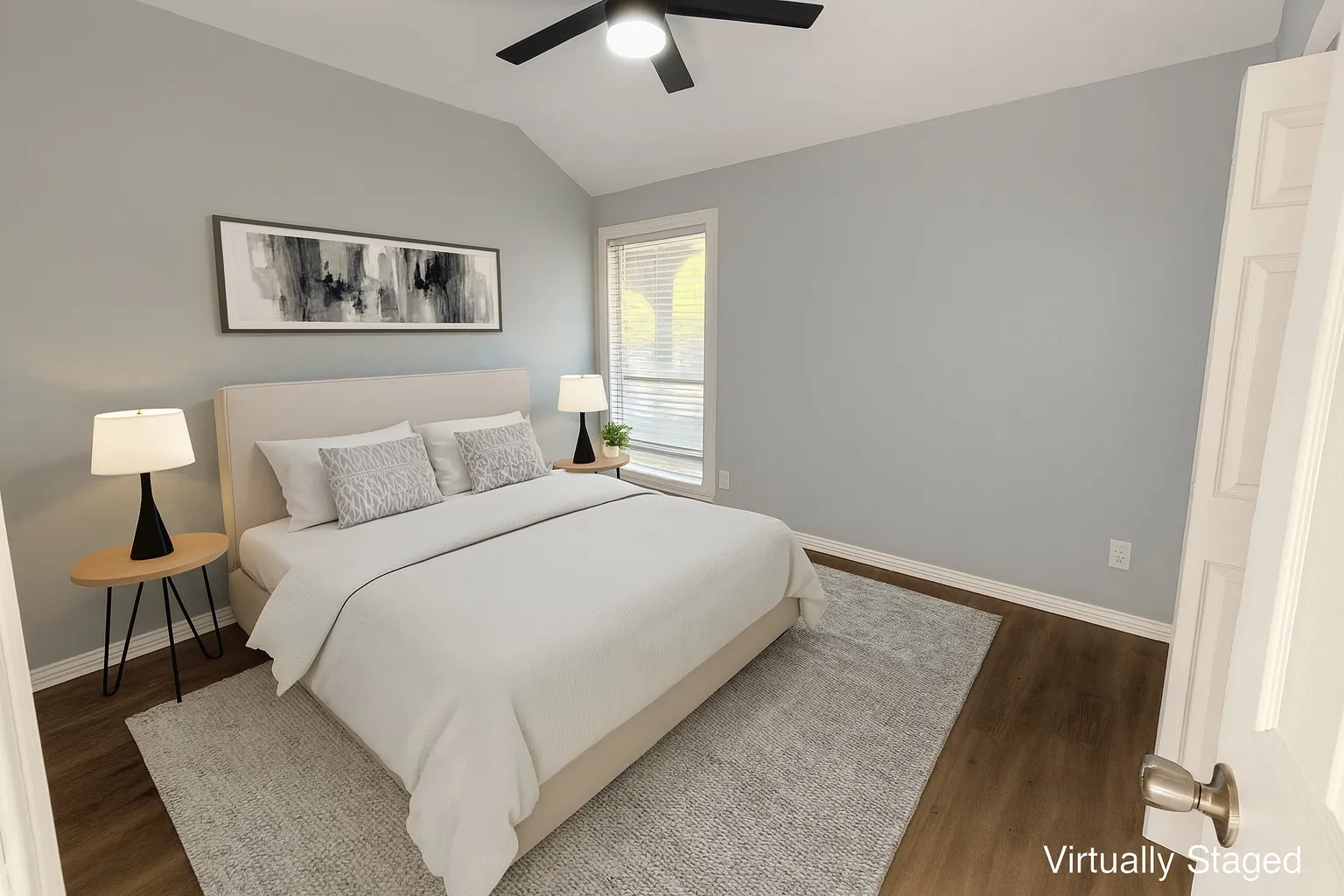 Bedroom with lofted ceiling, a ceiling fan, and wood finished floors