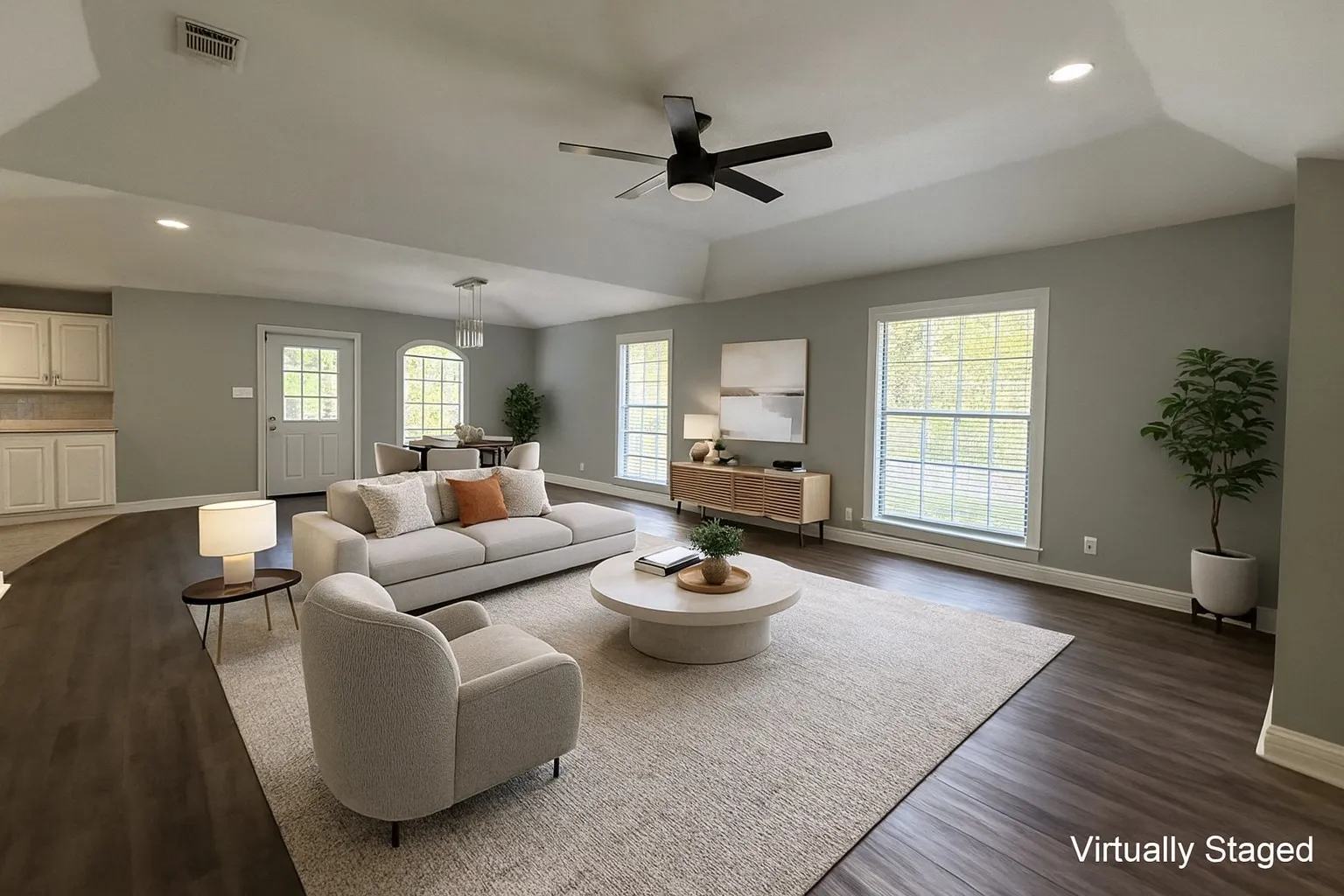 Living room with recessed lighting, healthy amount of natural light, a ceiling fan, dark wood finished floors, and vaulted ceiling